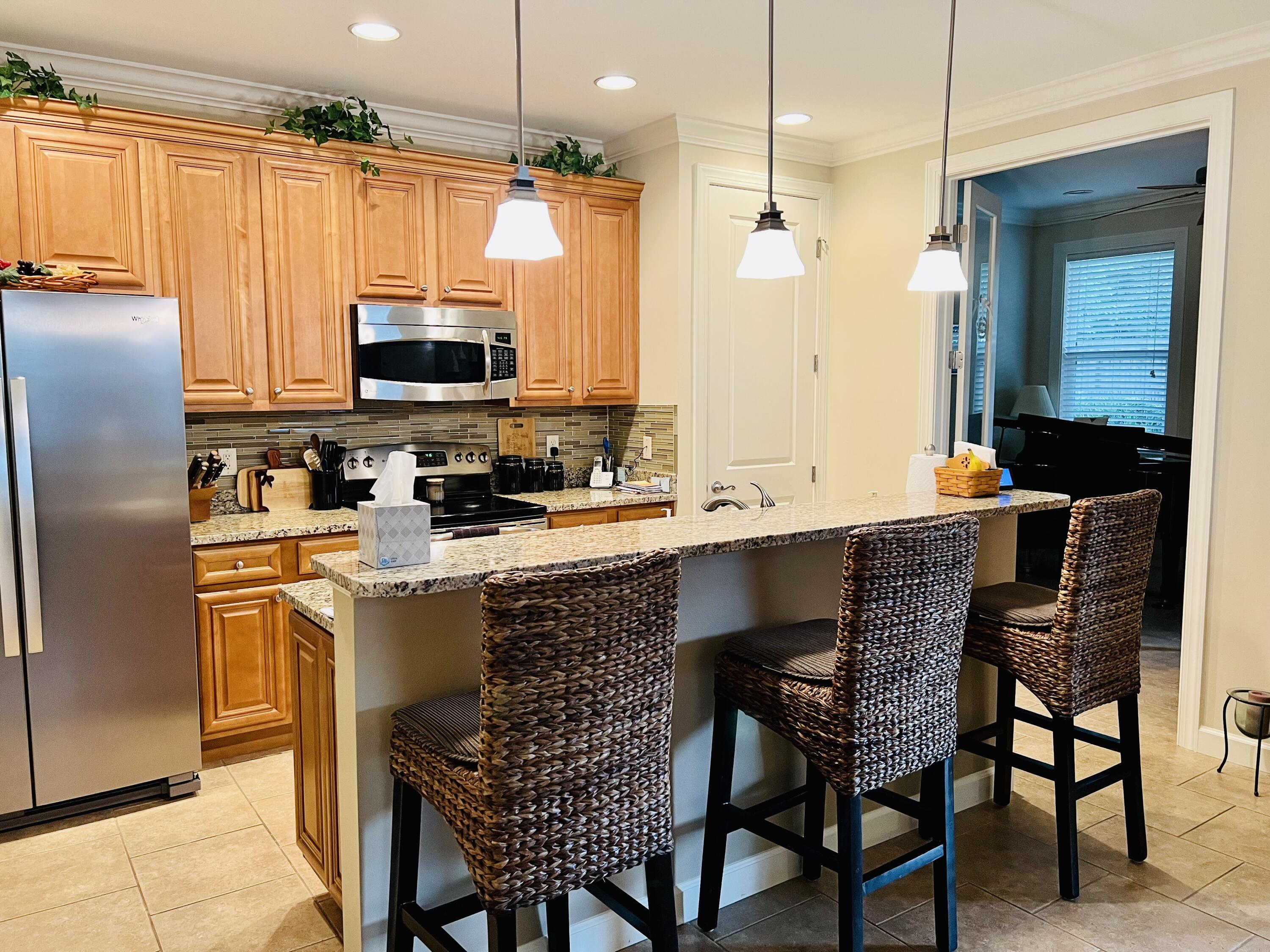 4248 Skipjack Cove Niceville, FL 32578 - Photo 23 of 64 a kitchen with stainless steel appliances granite countertop a stove a refrigerator a kitchen island a sink and a refrigerator