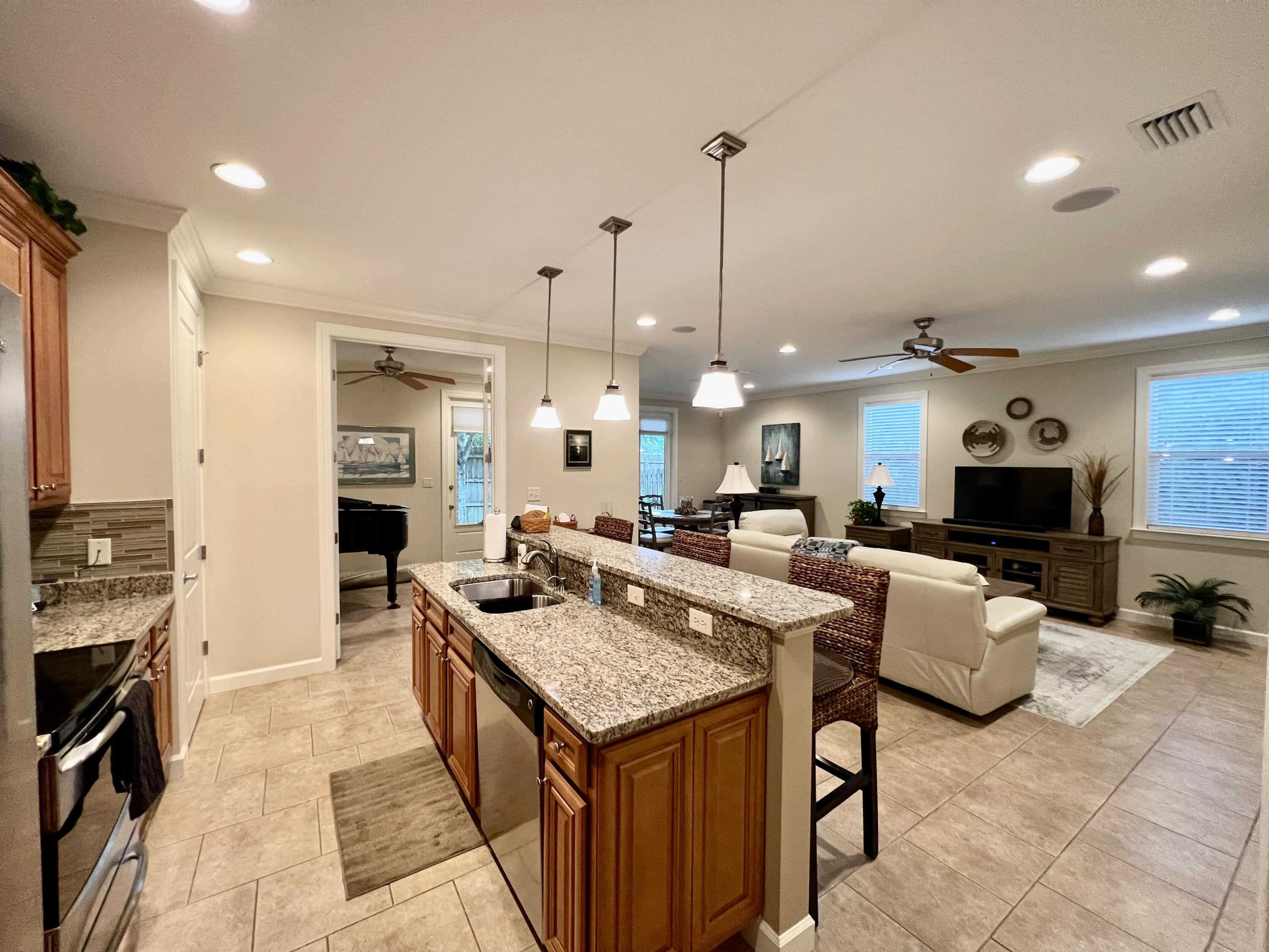 4248 Skipjack Cove Niceville, FL 32578 - Photo 25 of 64 a large kitchen with kitchen island a stove a sink a oven a dining table and chairs