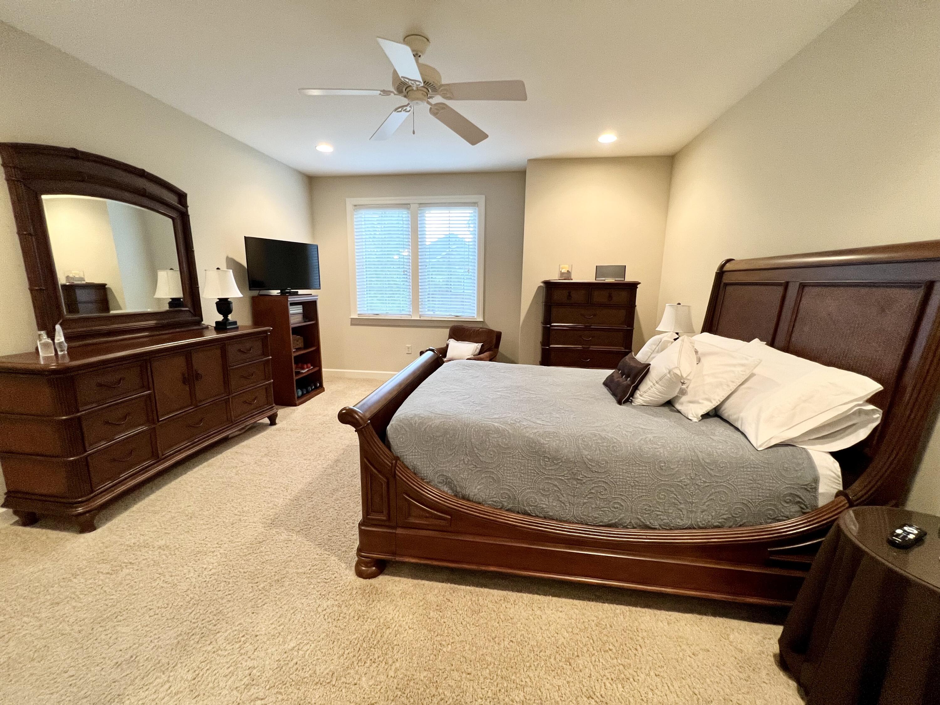 4248 Skipjack Cove Niceville, FL 32578 - Photo 39 of 64 a bedroom with a bed and wooden floor