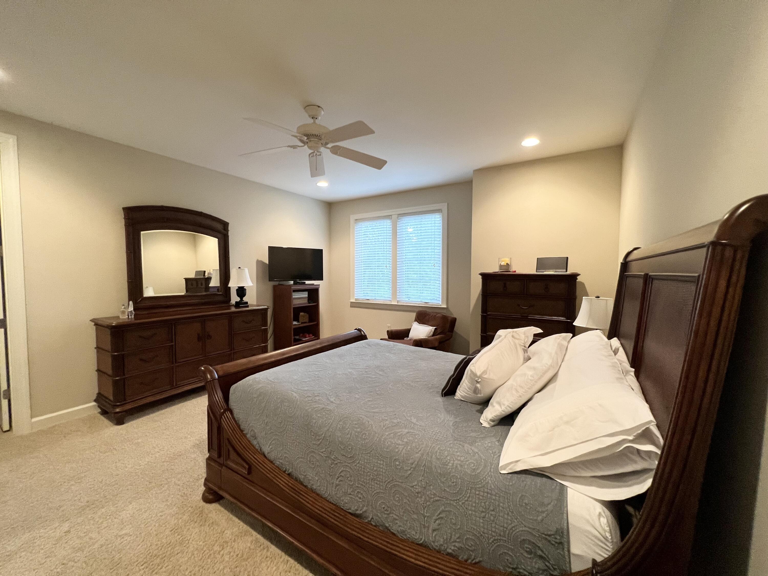 4248 Skipjack Cove Niceville, FL 32578 - Photo 40 of 64 a bedroom with a bed and a television in it