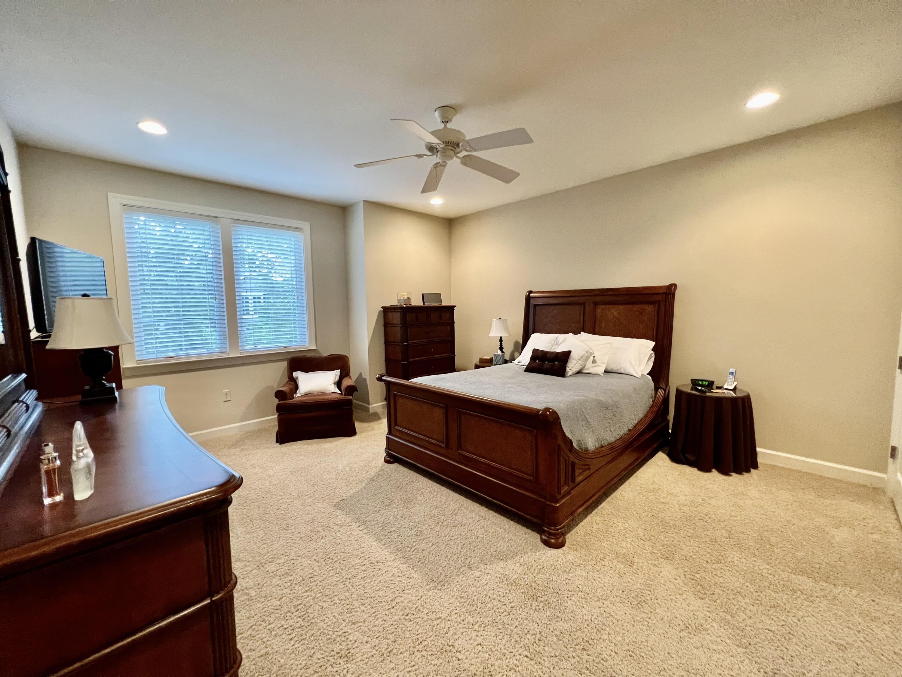 4248 Skipjack Cove Niceville, FL 32578 - Photo 41 of 64 a bedroom with a bed flat screen tv and a large window