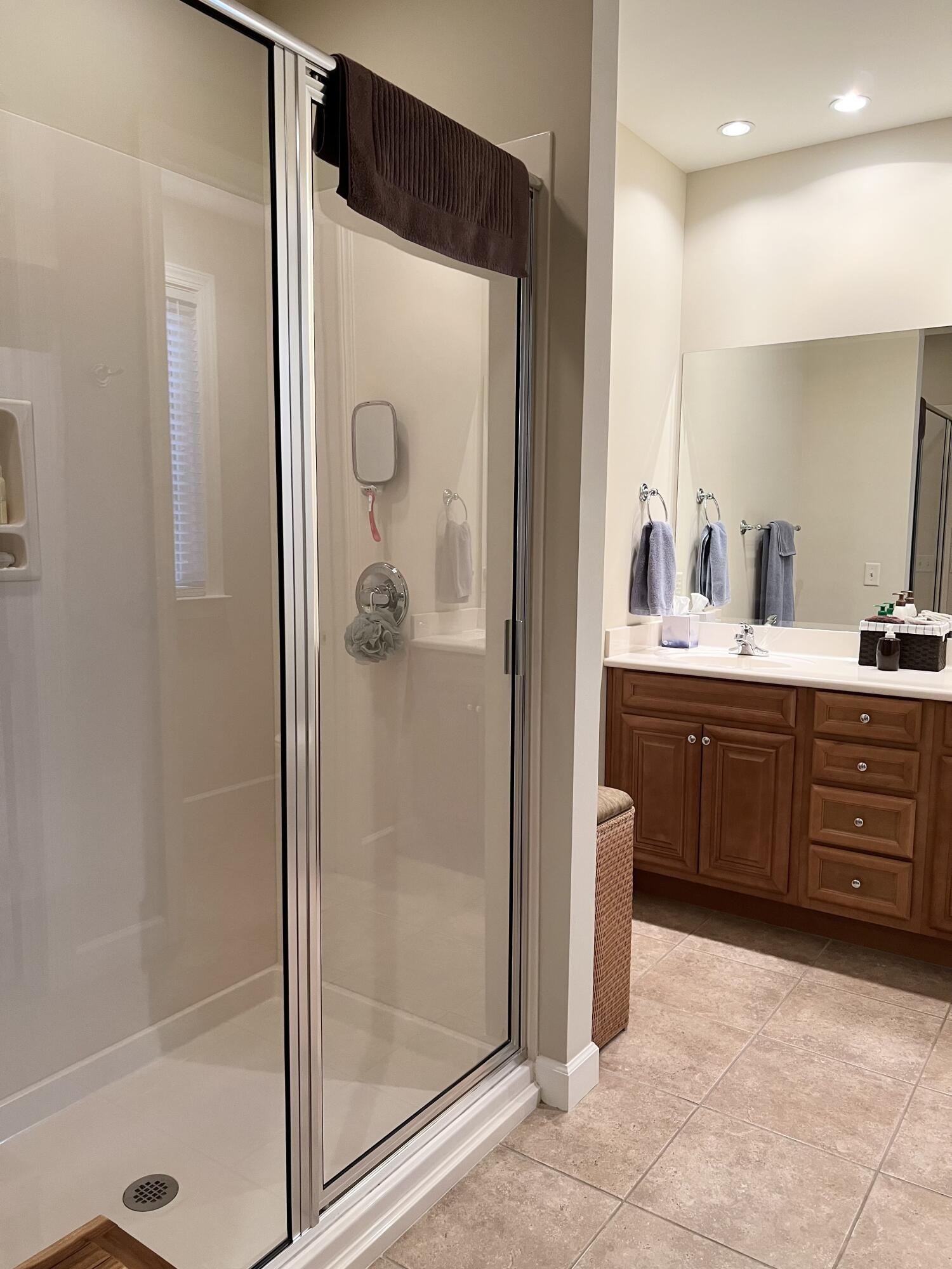 4248 Skipjack Cove Niceville, FL 32578 - Photo 44 of 64 a bathroom with a double vanity sink a mirror a shower and vanity