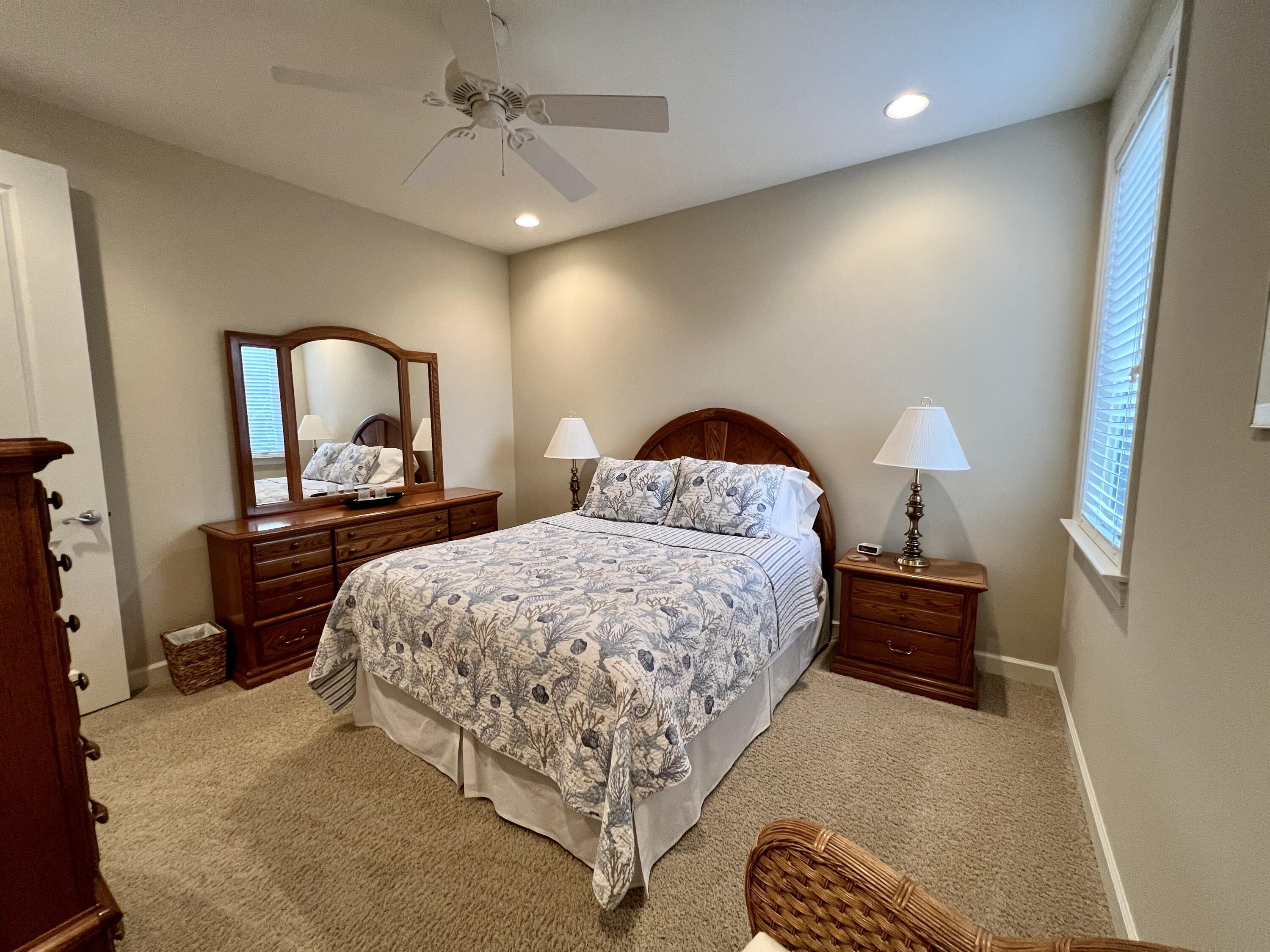 4248 Skipjack Cove Niceville, FL 32578 - Photo 50 of 64 a bedroom with a bed and dresser with mirror