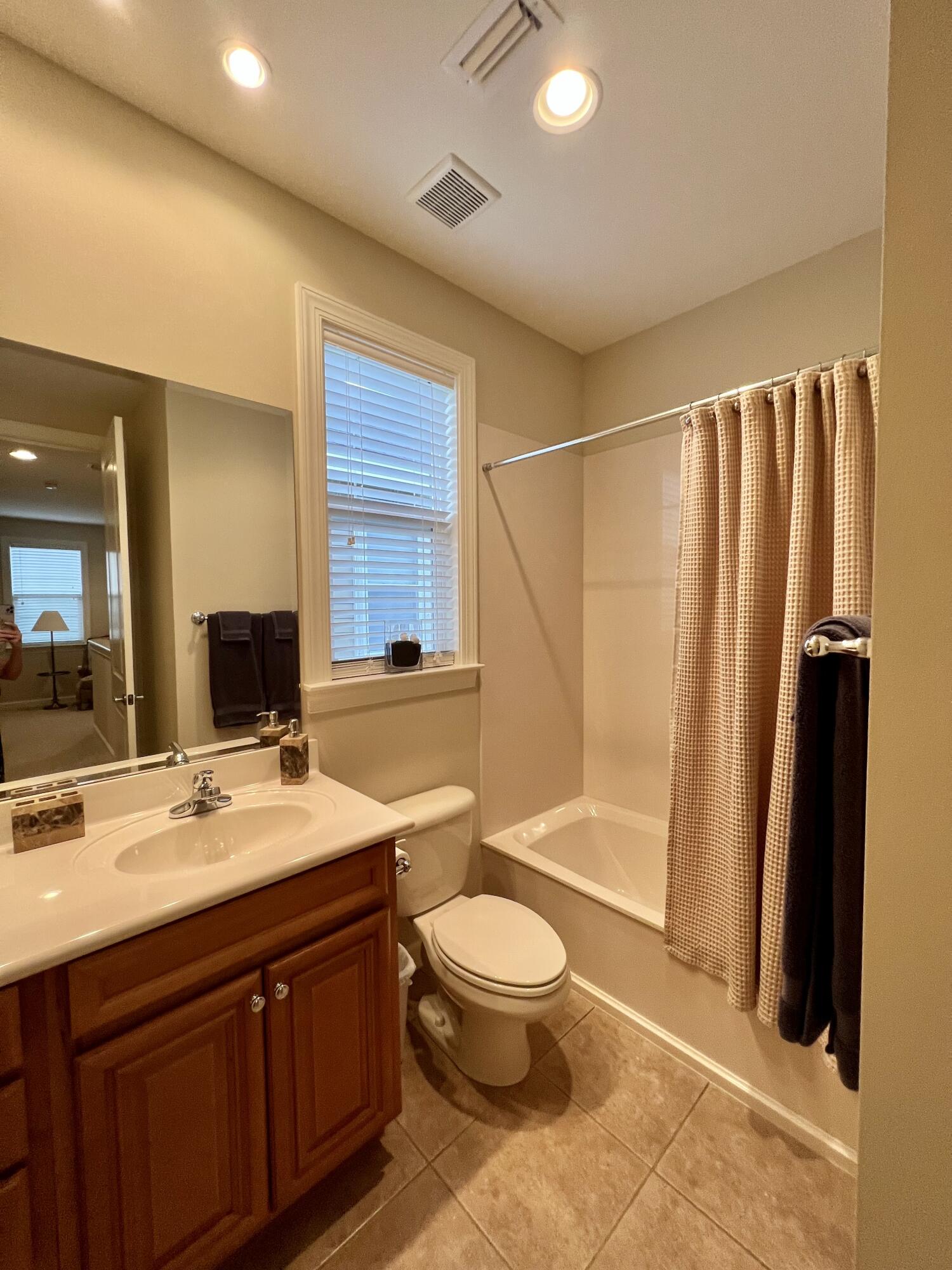 4248 Skipjack Cove Niceville, FL 32578 - Photo 54 of 64 a bathroom with a double vanity sink toilet mirror and shower