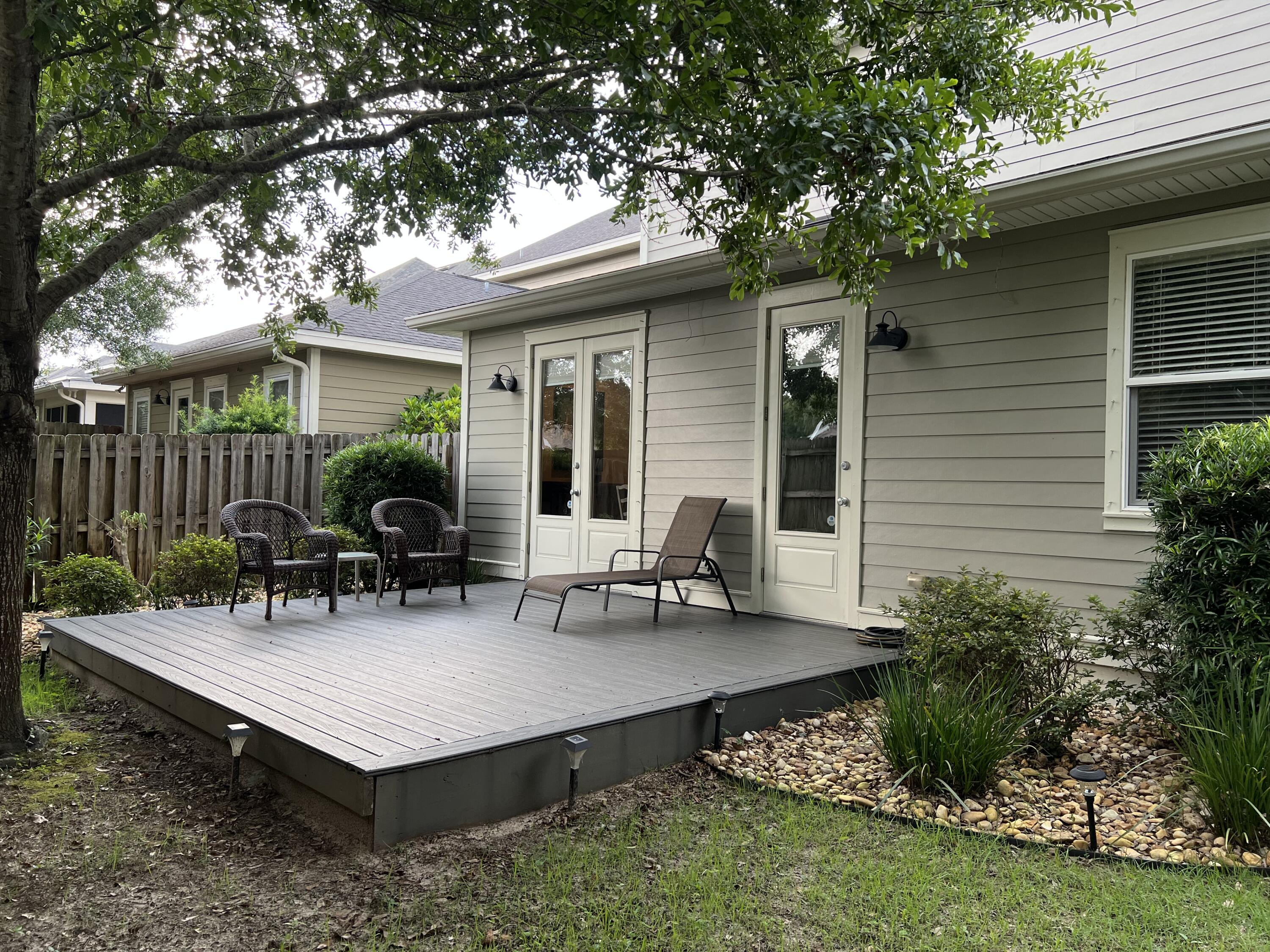 4248 Skipjack Cove Niceville, FL 32578 - Photo 56 of 64 a backyard of a house with table and chairs