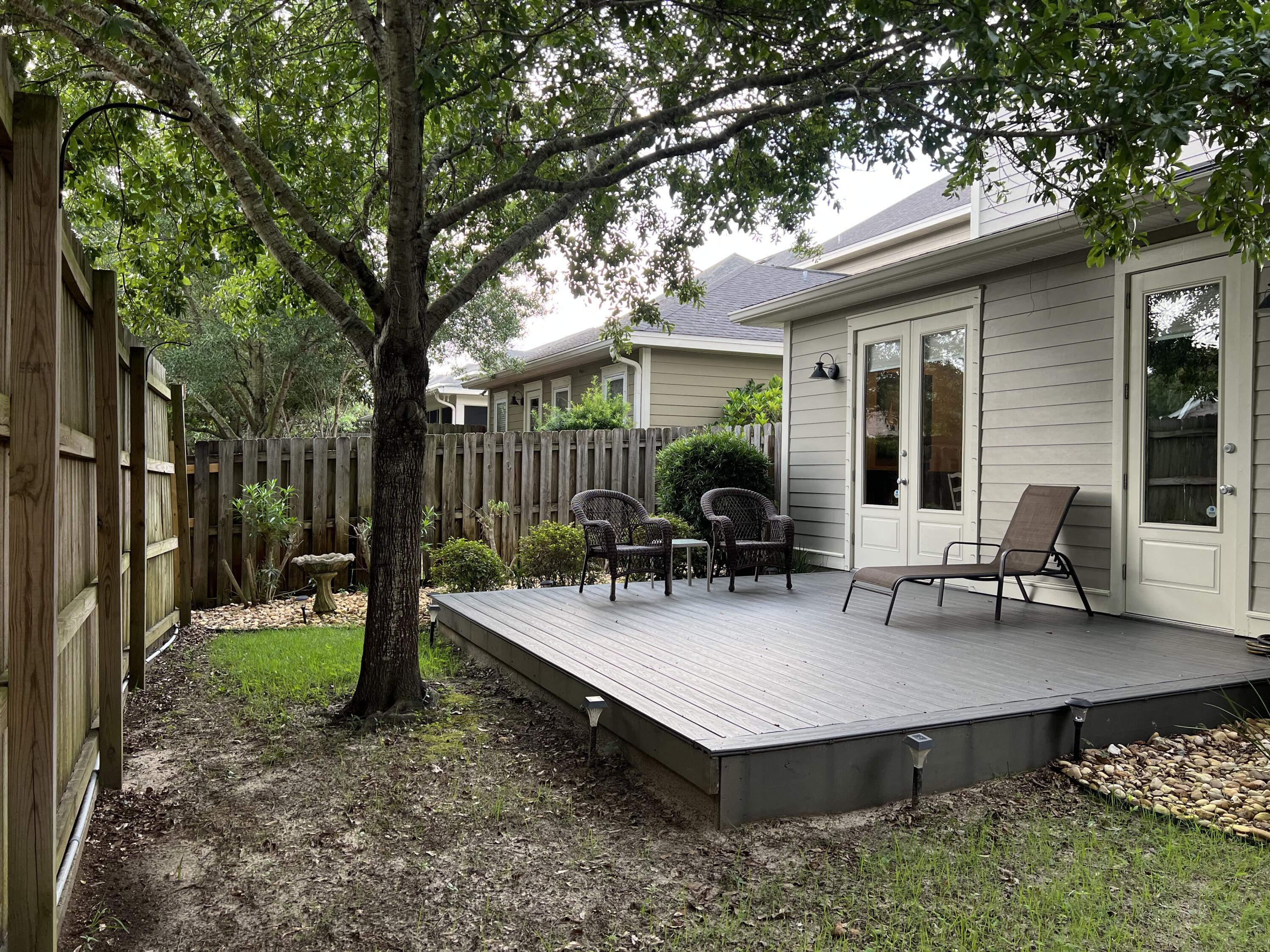4248 Skipjack Cove Niceville, FL 32578 - Photo 58 of 64 a backyard of a house with barbeque oven table and chairs
