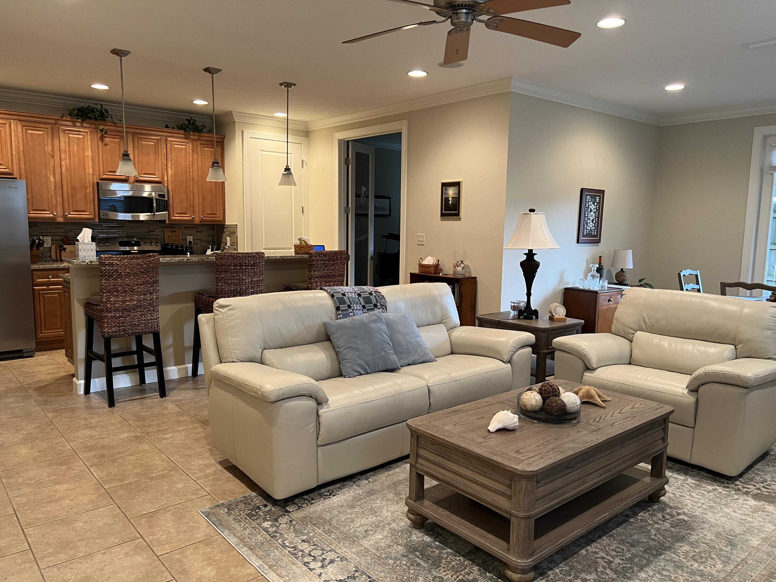 4248 Skipjack Cove Niceville, FL 32578 - Photo 8 of 64 a living room with furniture a kitchen view and a wooden floor