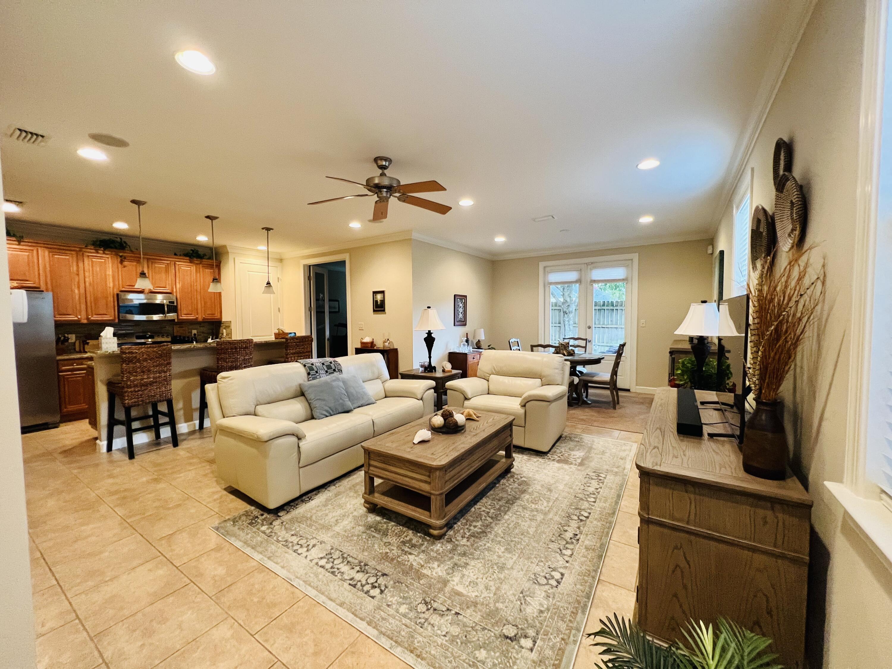 4248 Skipjack Cove Niceville, FL 32578 - Photo 9 of 64 a living room with furniture kitchen view and a chandelier
