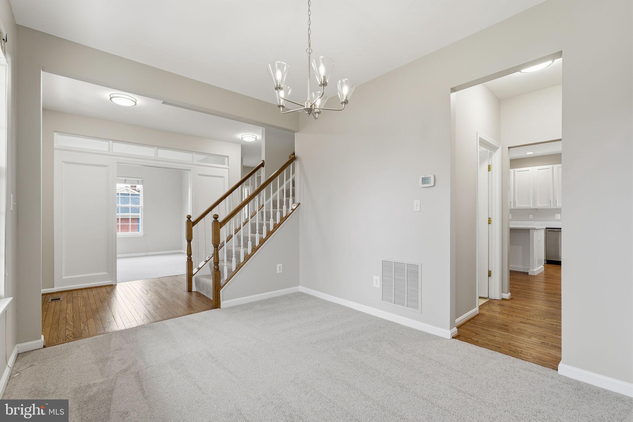 8310 Rolling Road Manassas, VA 20110 - Photo 13 of 58 a view of entryway and hall with wooden floor