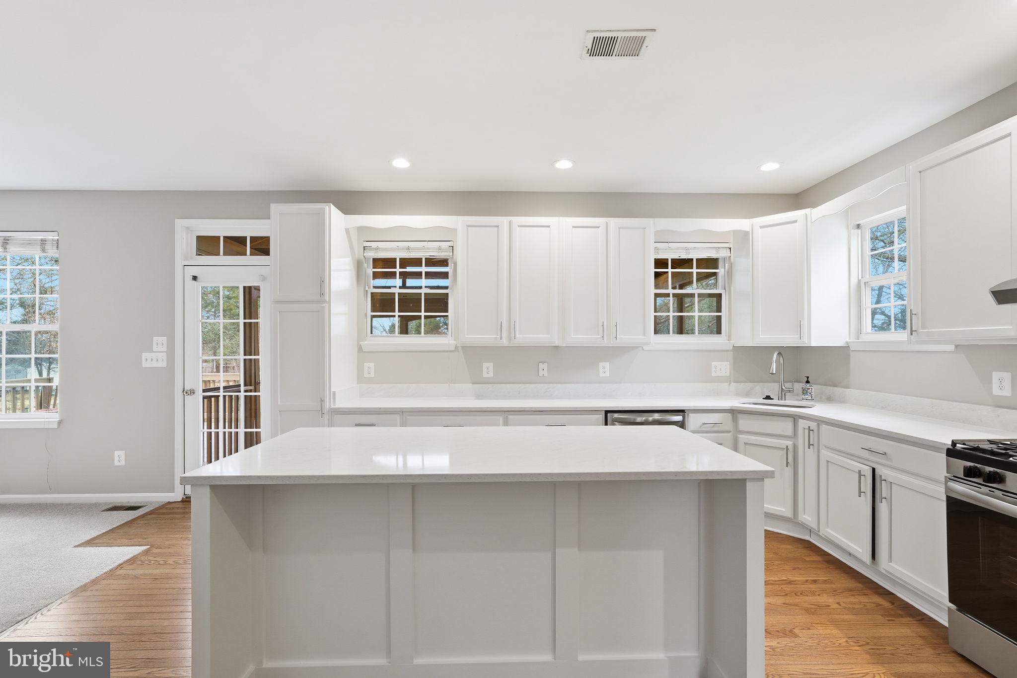 8310 Rolling Road Manassas, VA 20110 - Photo 19 of 58 a kitchen with a sink stove and cabinets