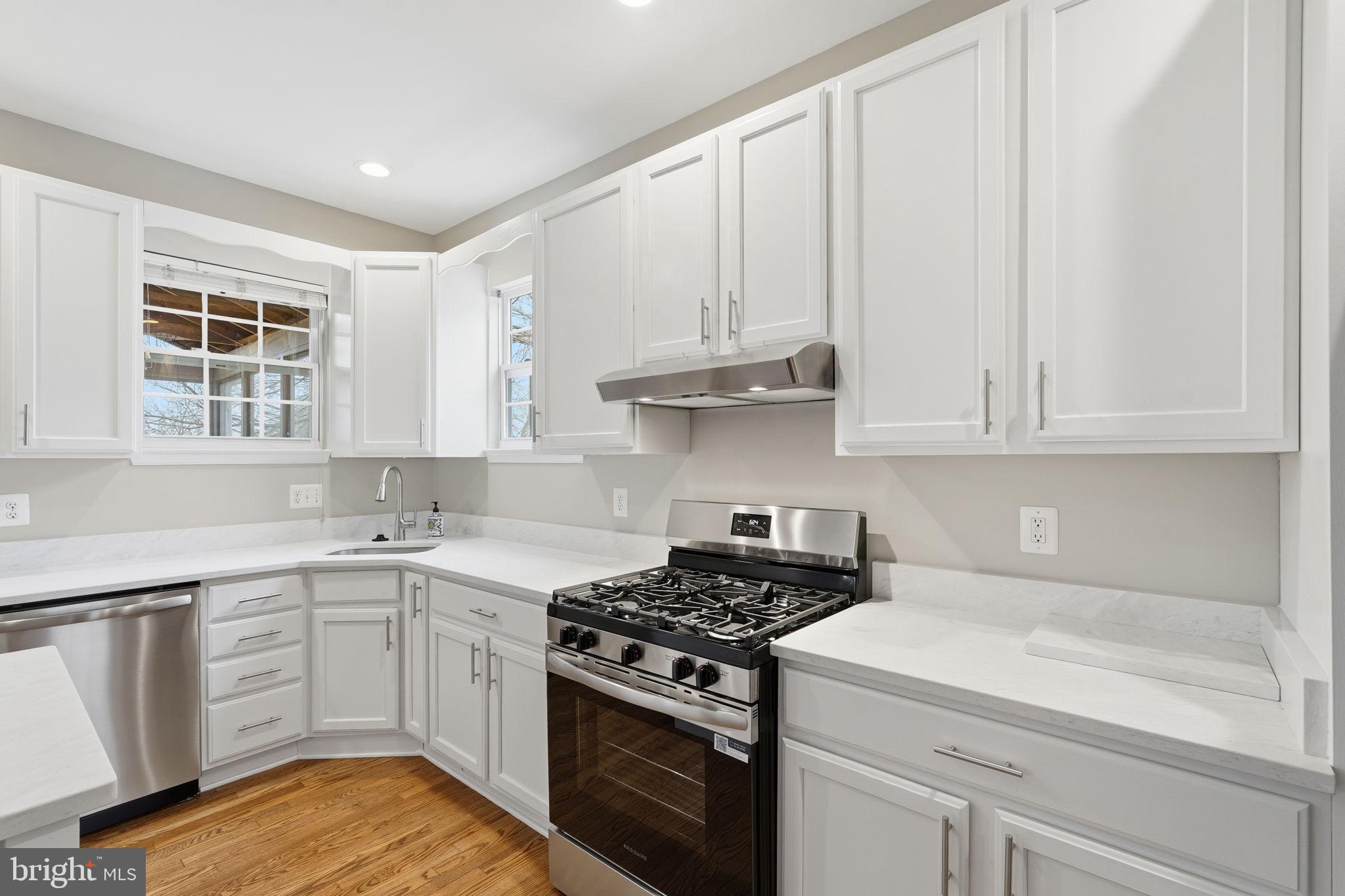 8310 Rolling Road Manassas, VA 20110 - Photo 20 of 58 a kitchen with white cabinets and appliances