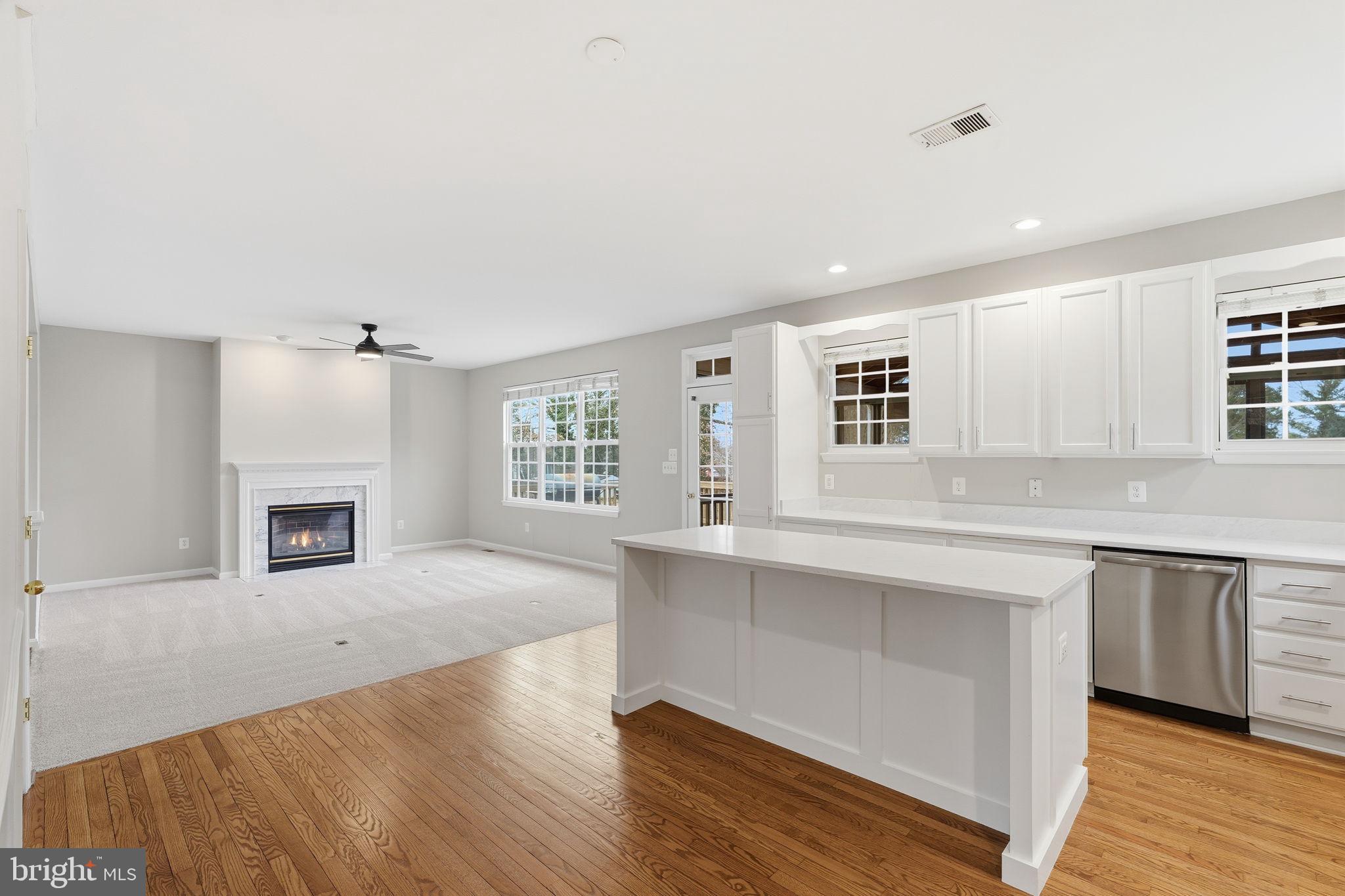 8310 Rolling Road Manassas, VA 20110 - Photo 58 of 58 a large kitchen with granite countertop a stove a sink white cabinets and wooden floor