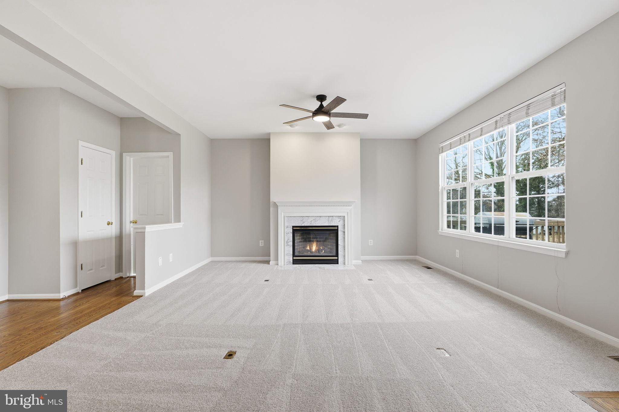 8310 Rolling Road Manassas, VA 20110 - Photo 22 of 58 a view of an empty room with a window and a fireplace
