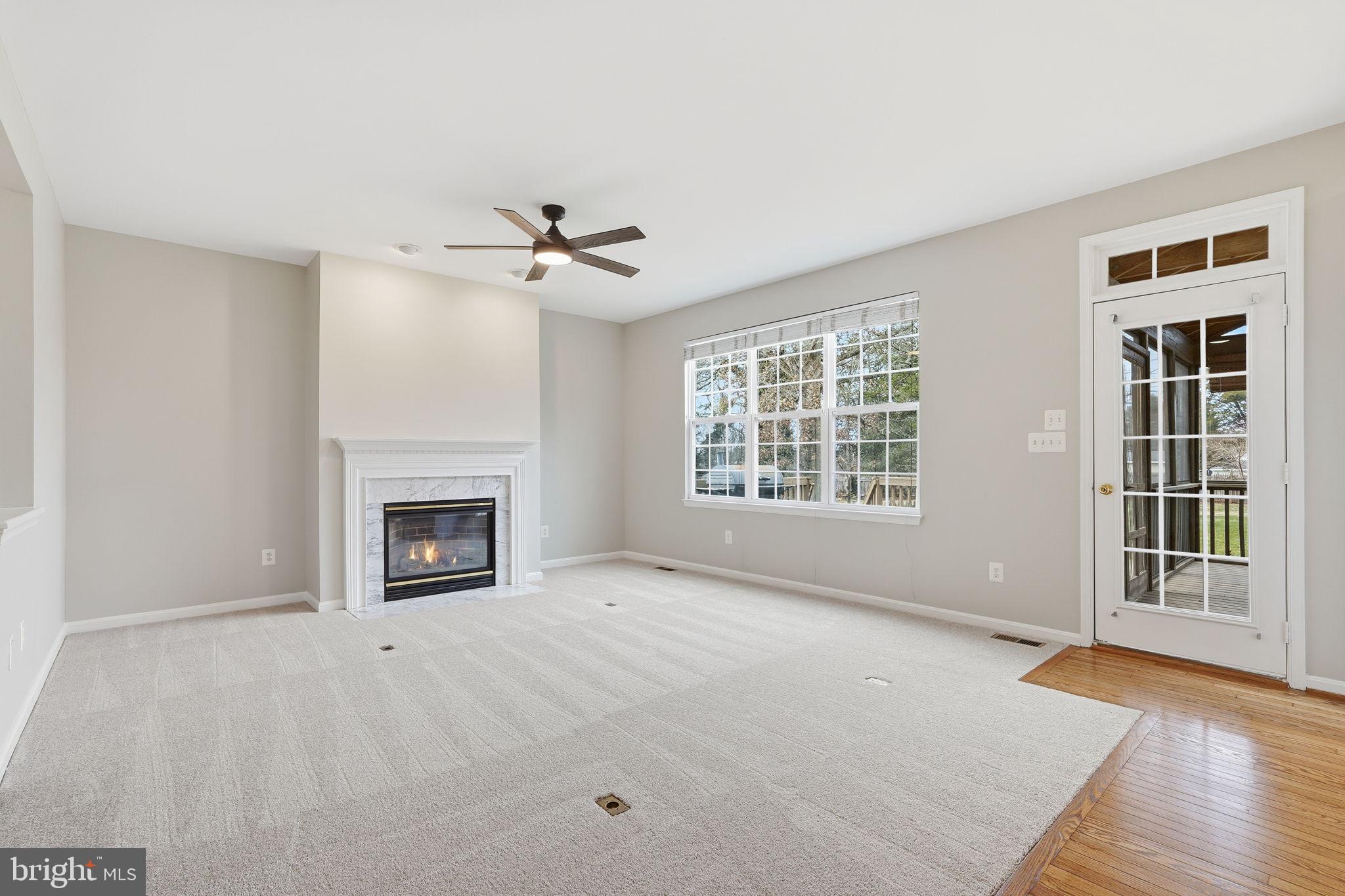 8310 Rolling Road Manassas, VA 20110 - Photo 23 of 58 a view of an empty room with a fireplace and a window
