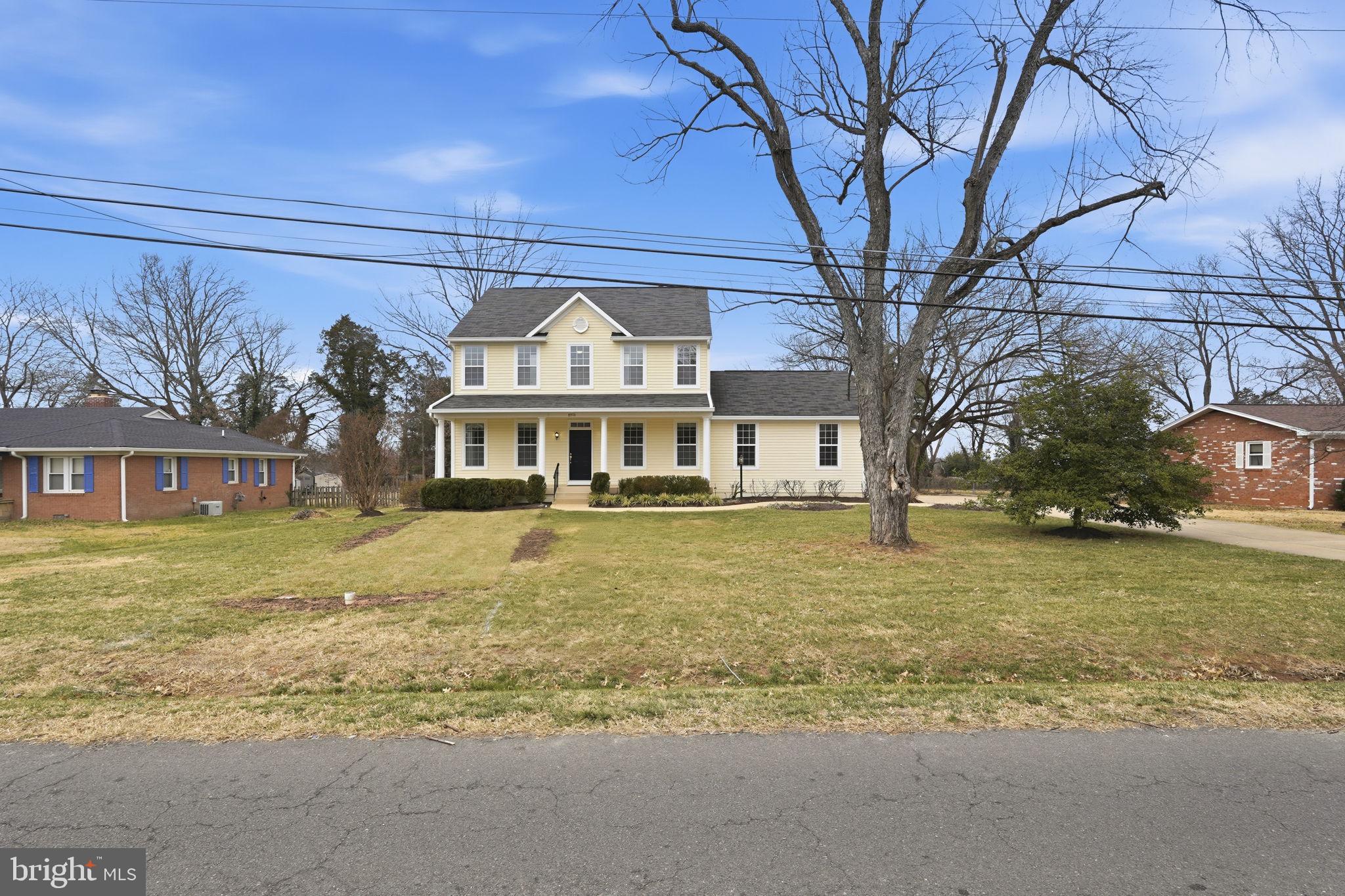 8310 Rolling Road Manassas, VA 20110 - Photo 5 of 58 a front view of a house with a yard
