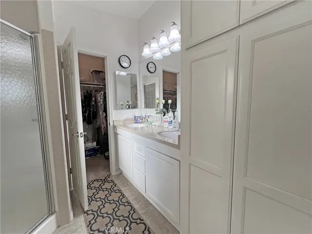 a bathroom with a sink a light fixture and a mirror
