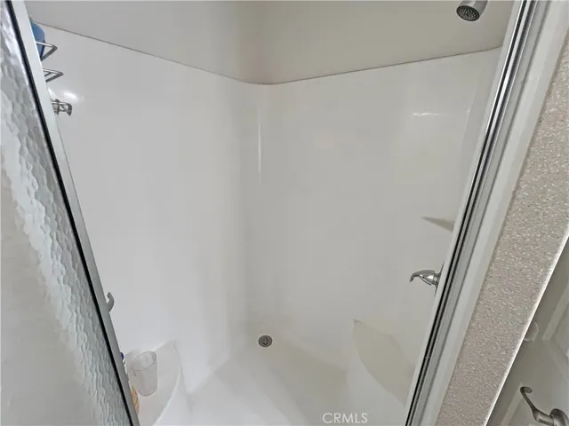 a bathroom with a shower and a sink