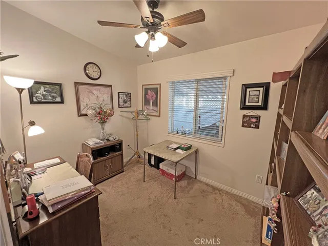 a living room with furniture a window and a flat screen tv