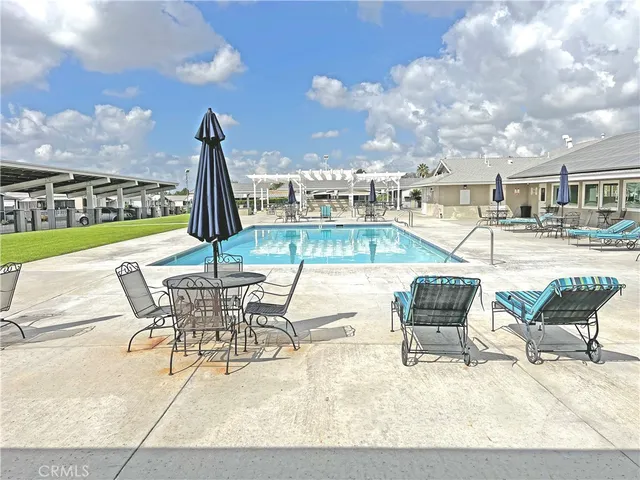 a view of a patio with dining table and chairs