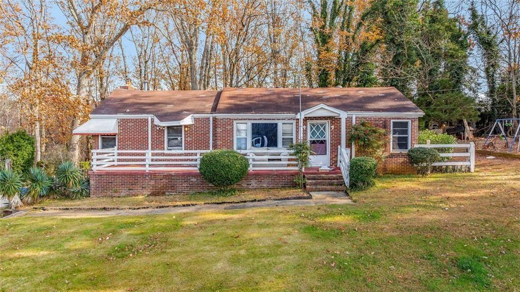 a house view with a sitting space and garden