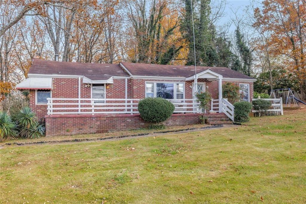 2626 White Sulphur Road Gainesville, GA 30501 - Photo 3 of 20 a front view of a house with a yard and trees