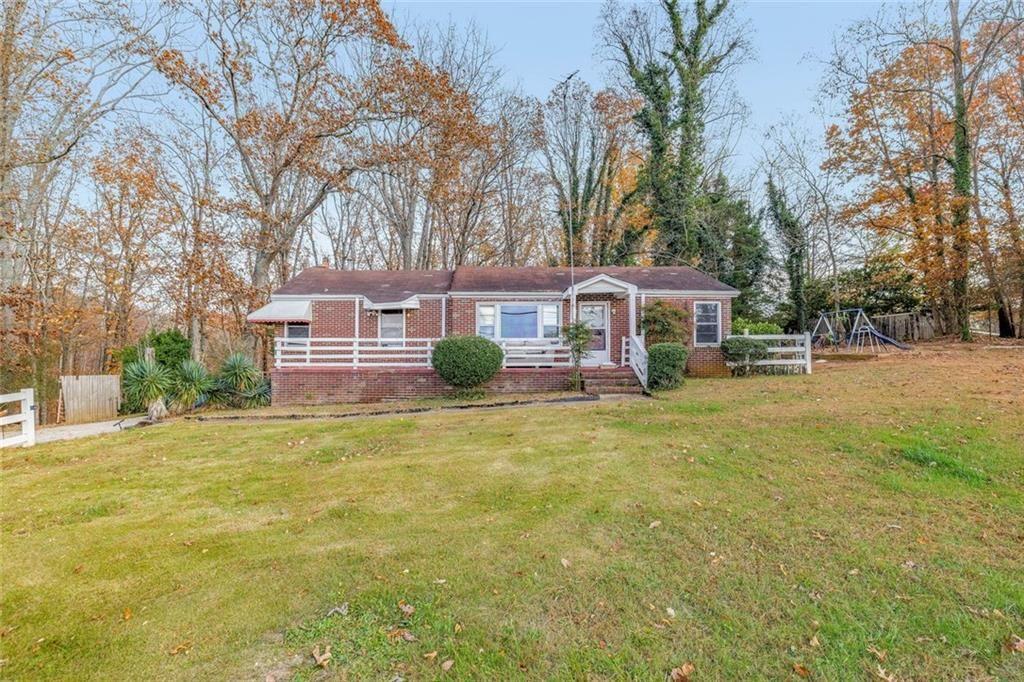 2626 White Sulphur Road Gainesville, GA 30501 - Photo 4 of 20 a front view of a house with a garden and tree