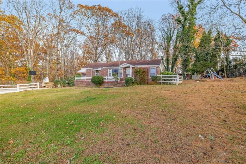 2626 White Sulphur Road Gainesville, GA 30501 - Photo 5 of 20 a front view of a house with a yard and trees