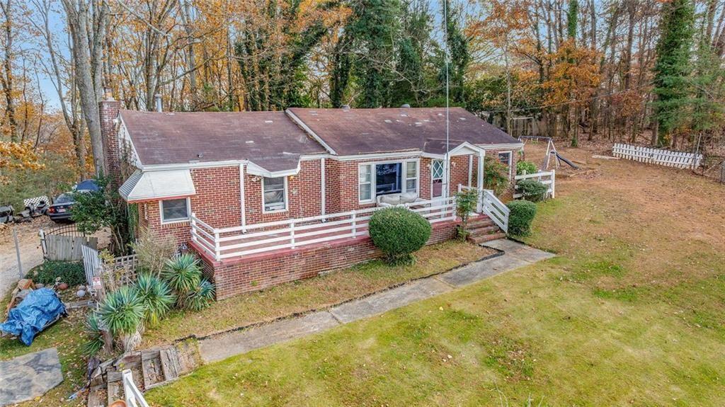 2626 White Sulphur Road Gainesville, GA 30501 - Photo 7 of 20 a view of a house with a yard and plants