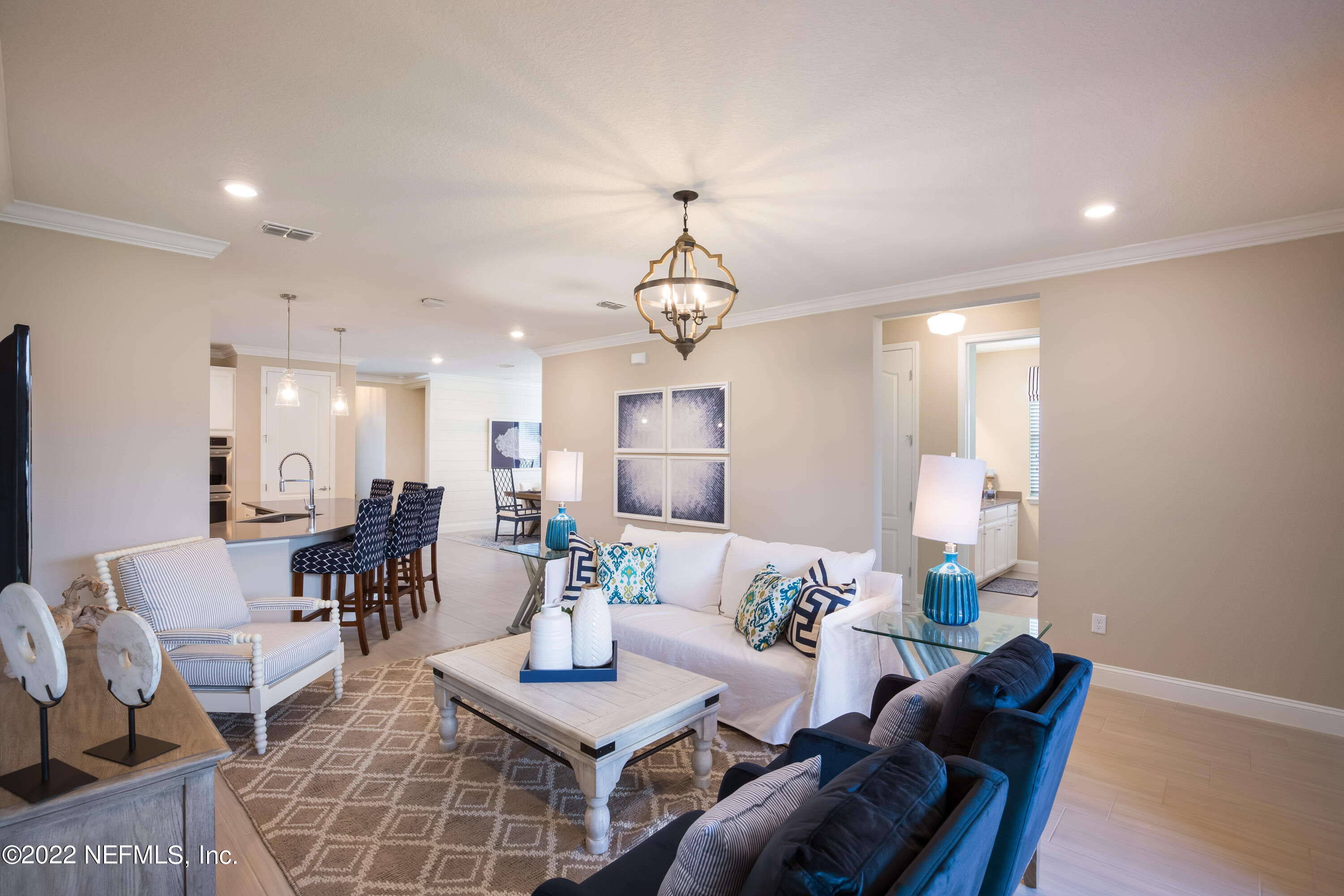 364 Clearview Drive St. Augustine, FL 32092 - Photo 7 of 10 a living room with furniture a chandelier and a table