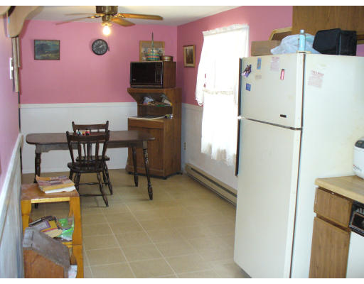 98 River Road Ware, MA 01082 - Photo 3 of 5 a kitchen with a refrigerator and a table