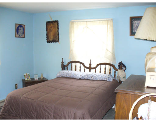 98 River Road Ware, MA 01082 - Photo 5 of 5 a bedroom with a bed and a painting on the wall