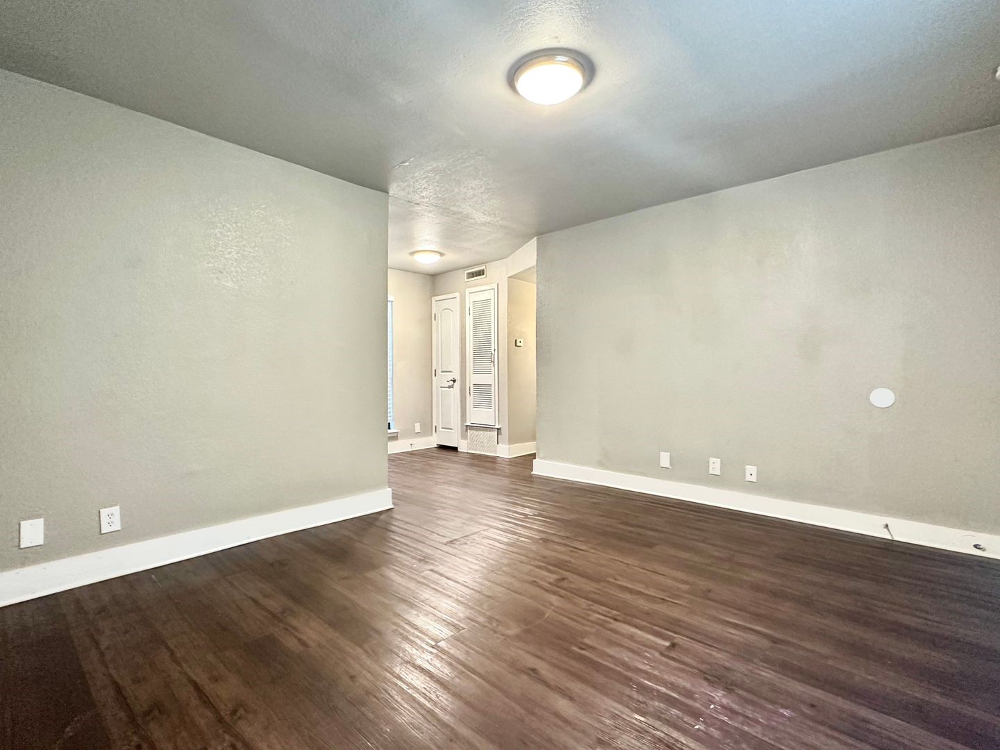 4316 Bull Creek Road, Unit 107 Austin, TX 78731 - Photo 5 of 8 This interior space features hardwood flooring and light-colored walls