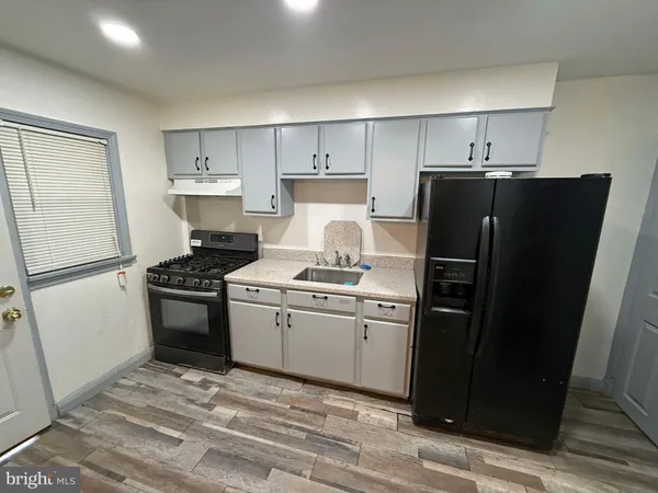 a kitchen with a refrigerator stove and sink
