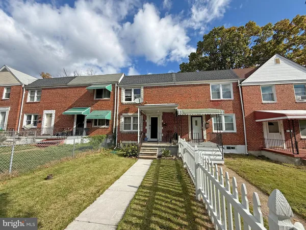 a front view of a house with a yard table and chairs
