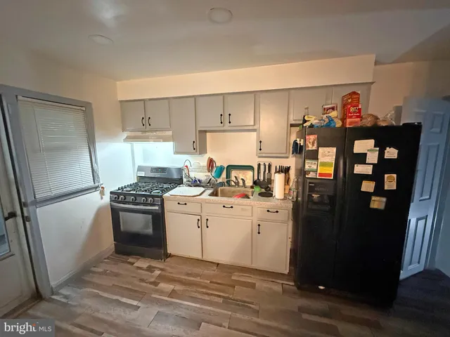 a kitchen with stainless steel appliances a refrigerator stove and sink