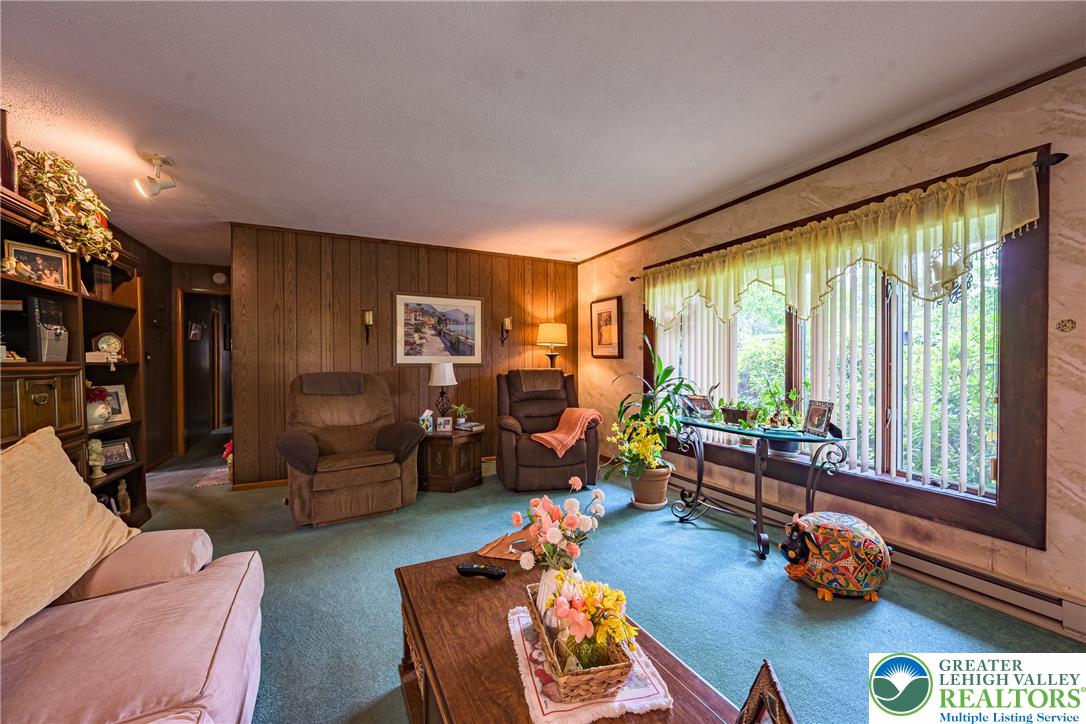 678 Interchange Road Kresgeville, PA 18333 - Photo 22 of 45 A comforting living room offers soft carpeting and ample natural light from generous windows.