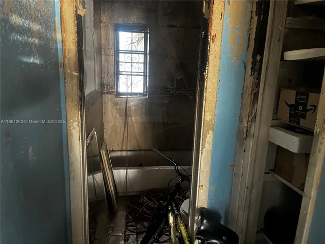 a view of a porch with chairs and potted plants