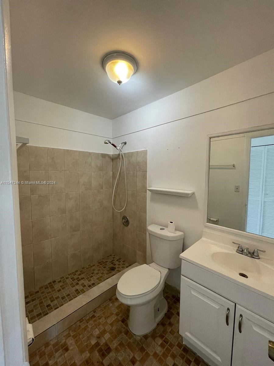 The Crossings Miami, FL 33186 - Photo 5 of 19 a bathroom with a granite countertop toilet a sink and a shower