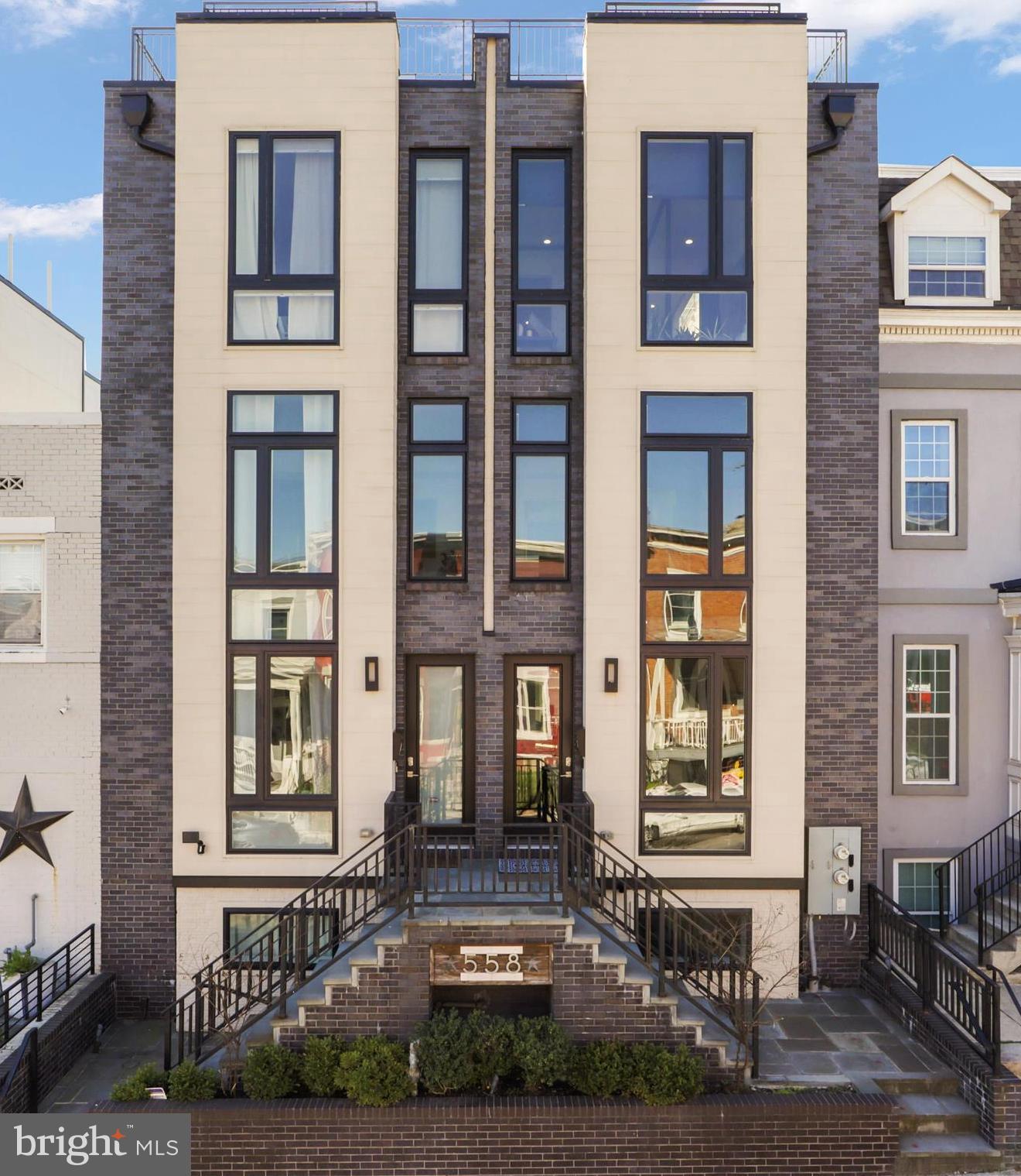 558 Harvard Street Northwest, Unit B Washington, DC 20001 - Photo 1 of 67 a front view of a brick building with many windows