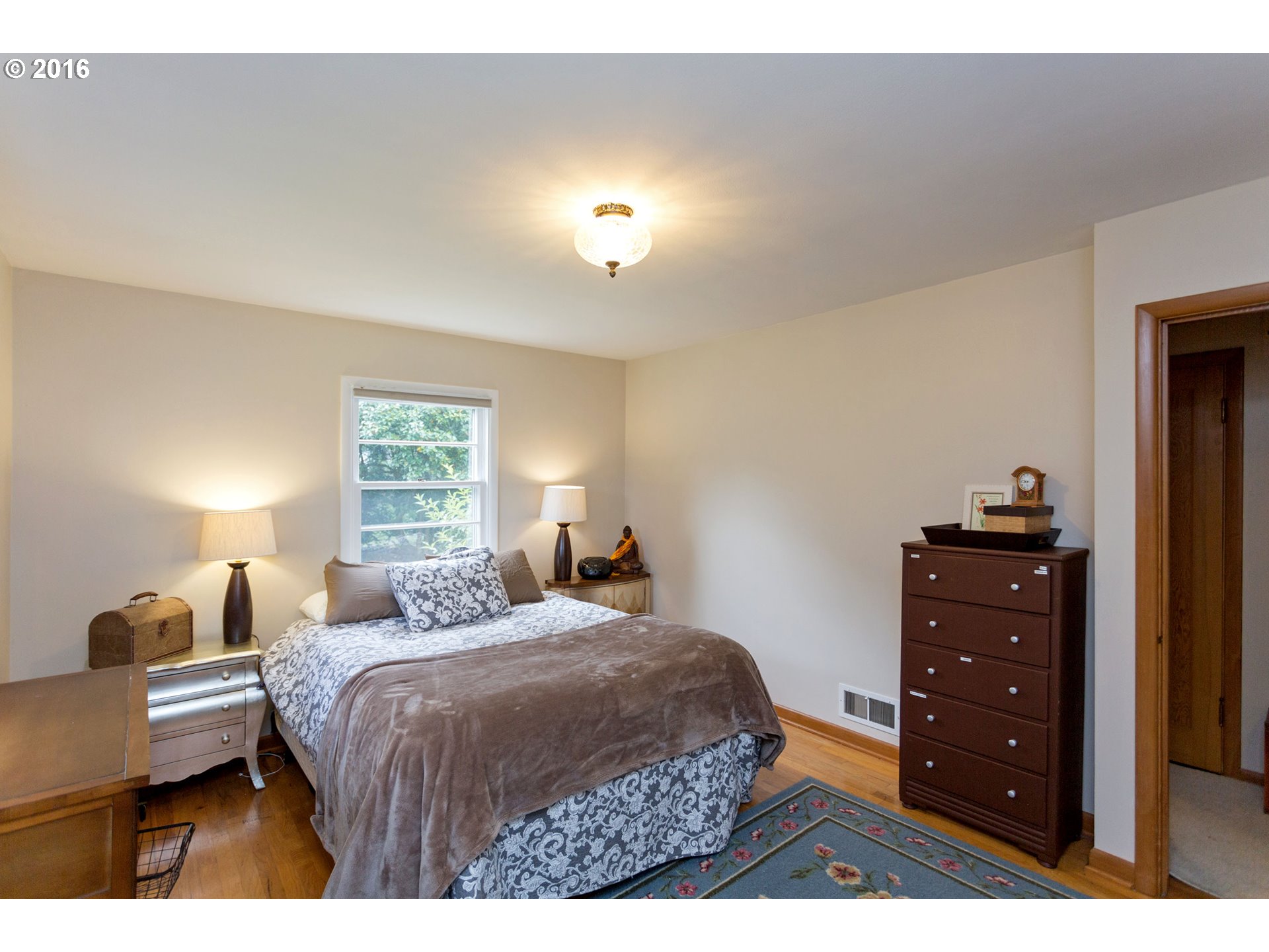 8770 Southwest Garden Home Road Portland, OR 97223 - Photo 15 of 30 a bedroom with a bed and a dresser