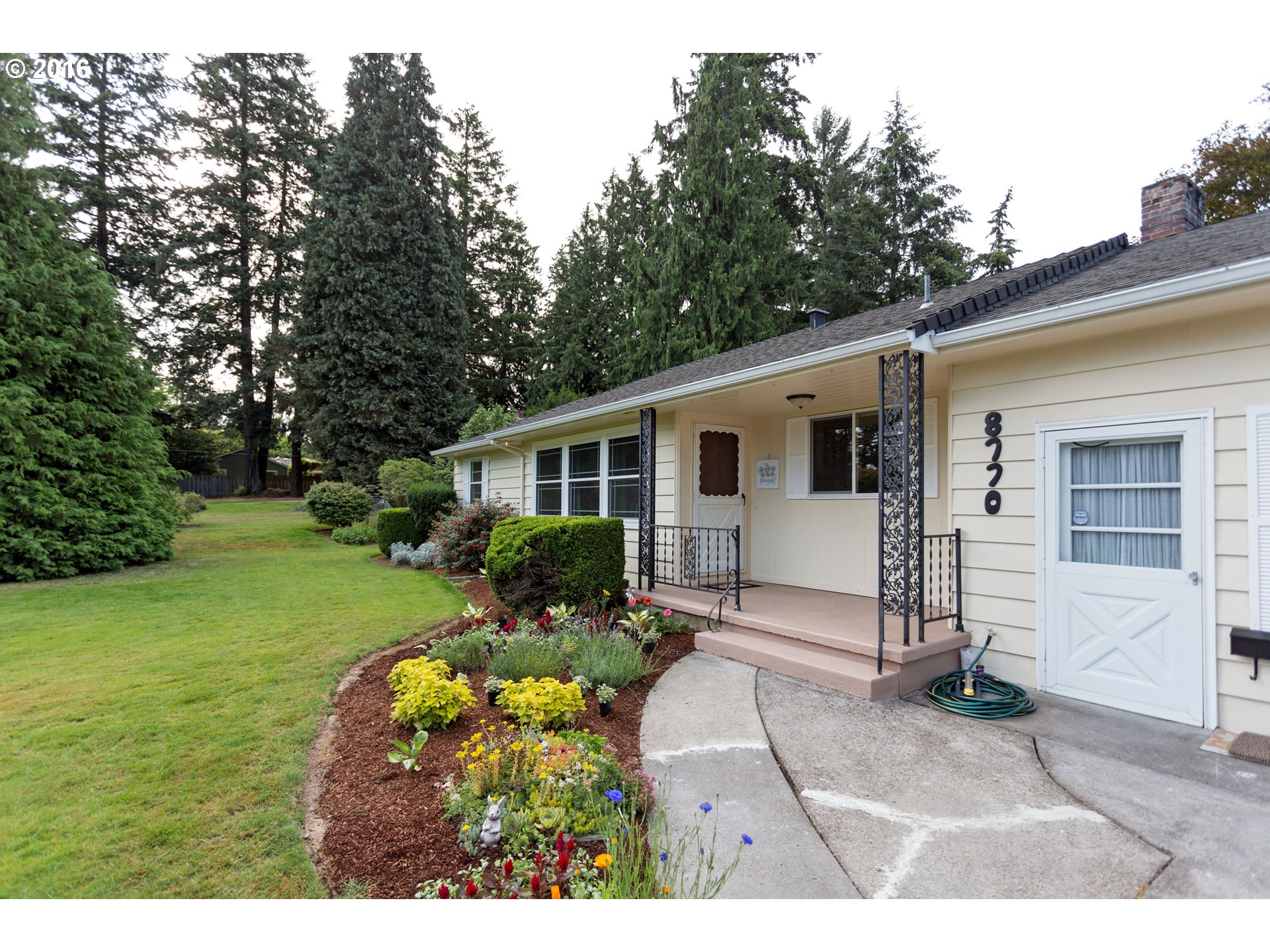 8770 Southwest Garden Home Road Portland, OR 97223 - Photo 3 of 30 a view of a house with backyard and sitting area