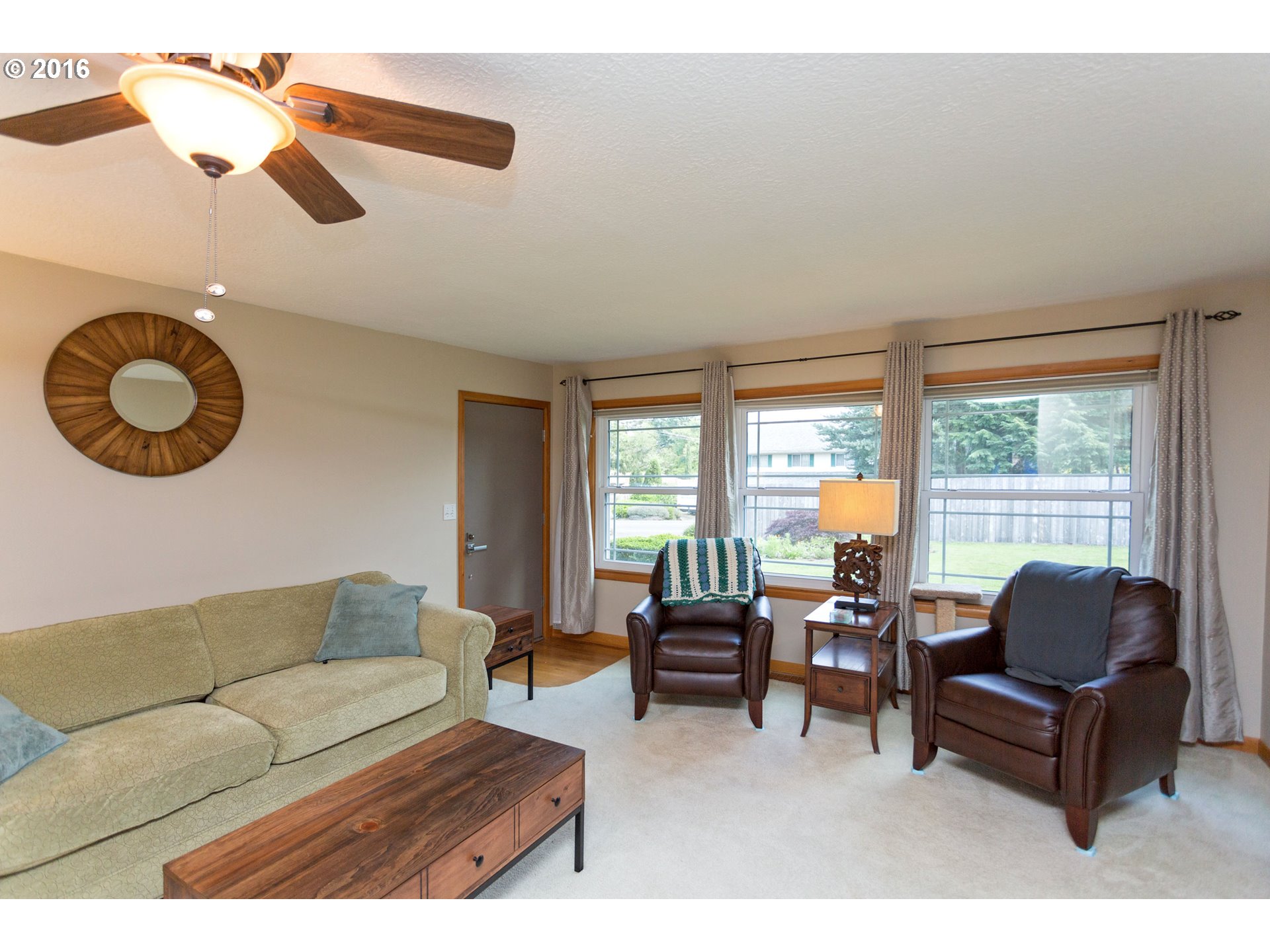 8770 Southwest Garden Home Road Portland, OR 97223 - Photo 5 of 30 a living room with furniture and a large window