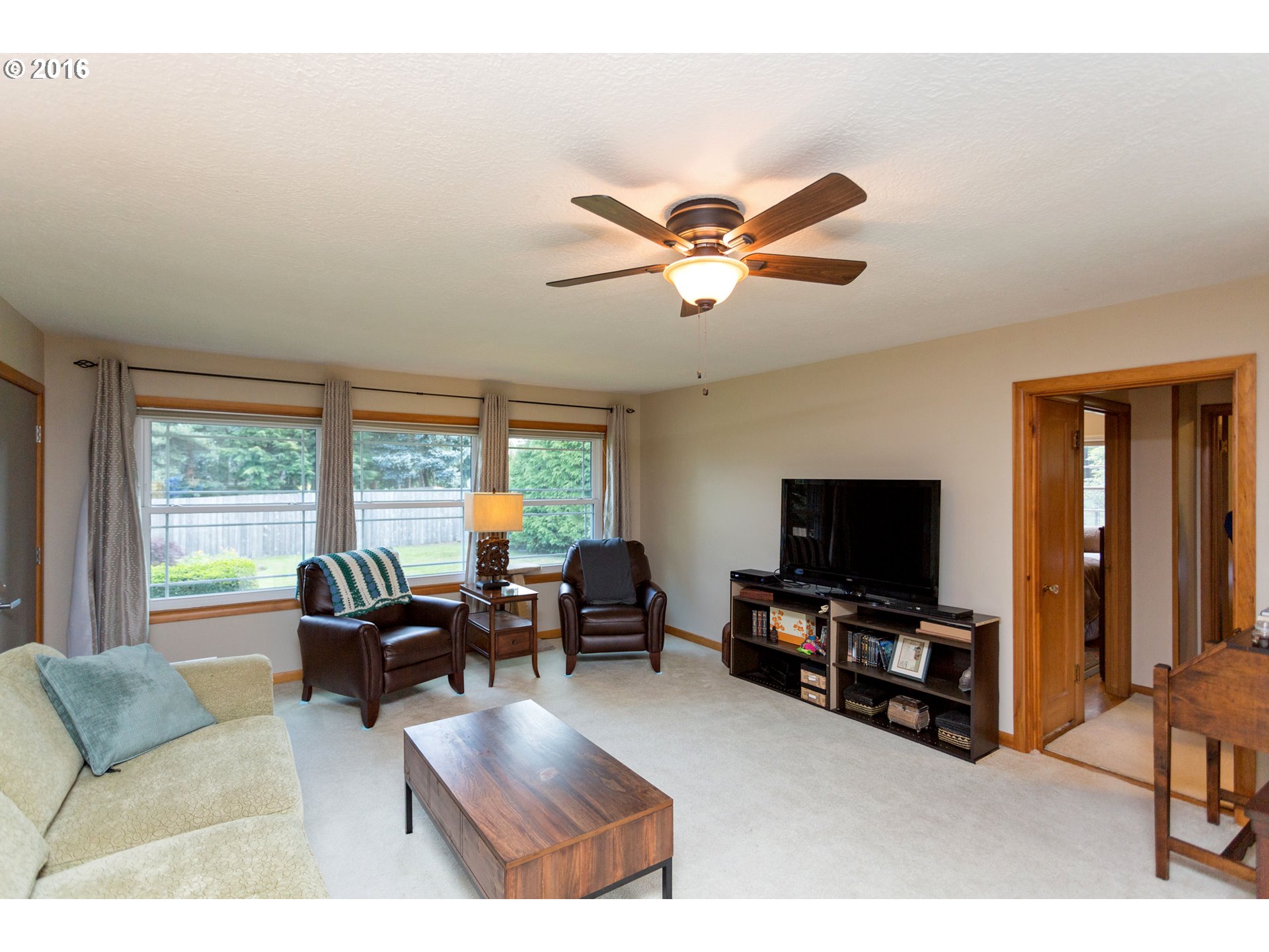 8770 Southwest Garden Home Road Portland, OR 97223 - Photo 6 of 30 a living room with furniture and a flat screen tv
