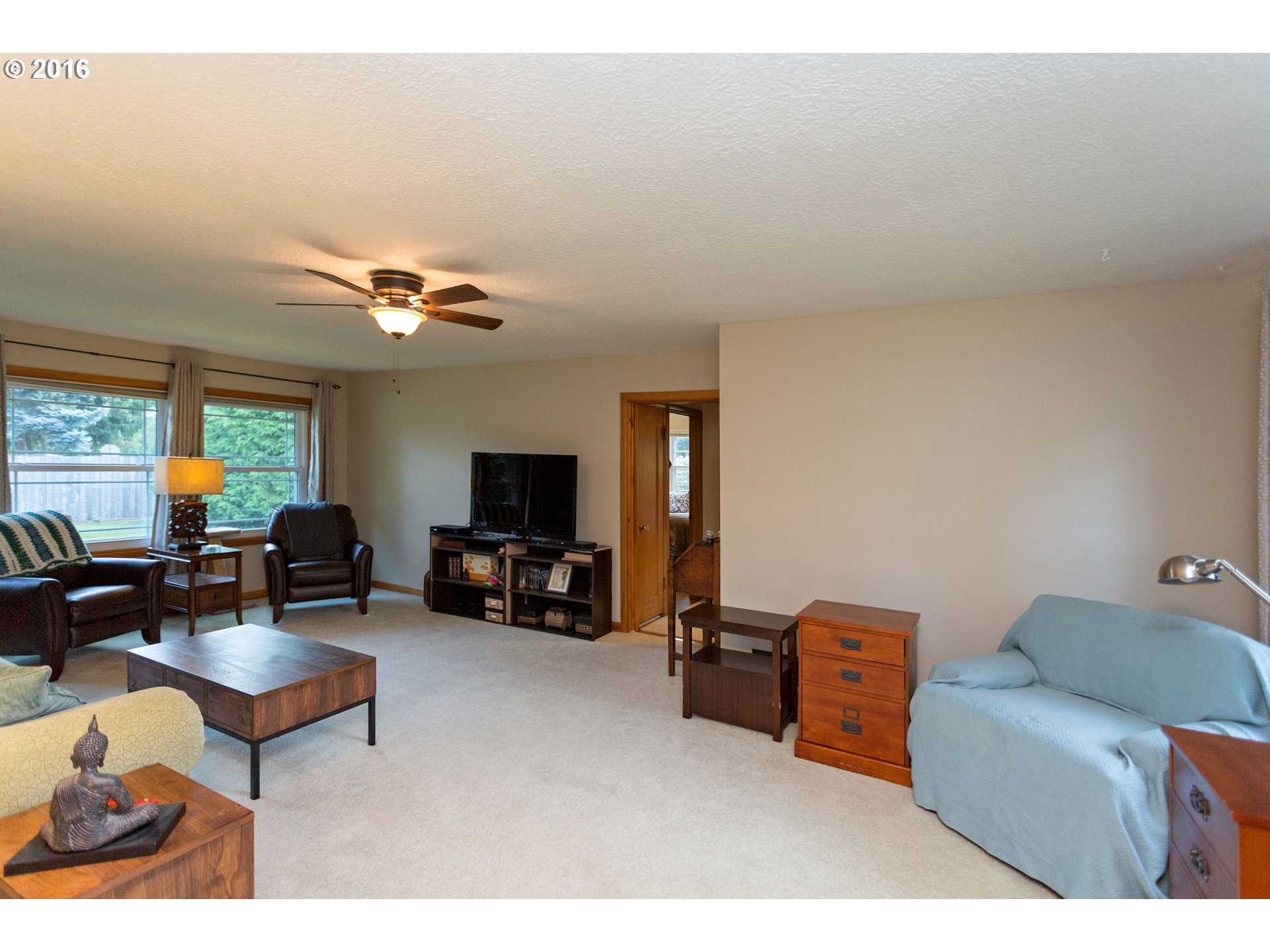 8770 Southwest Garden Home Road Portland, OR 97223 - Photo 8 of 30 a living room with furniture and a flat screen tv
