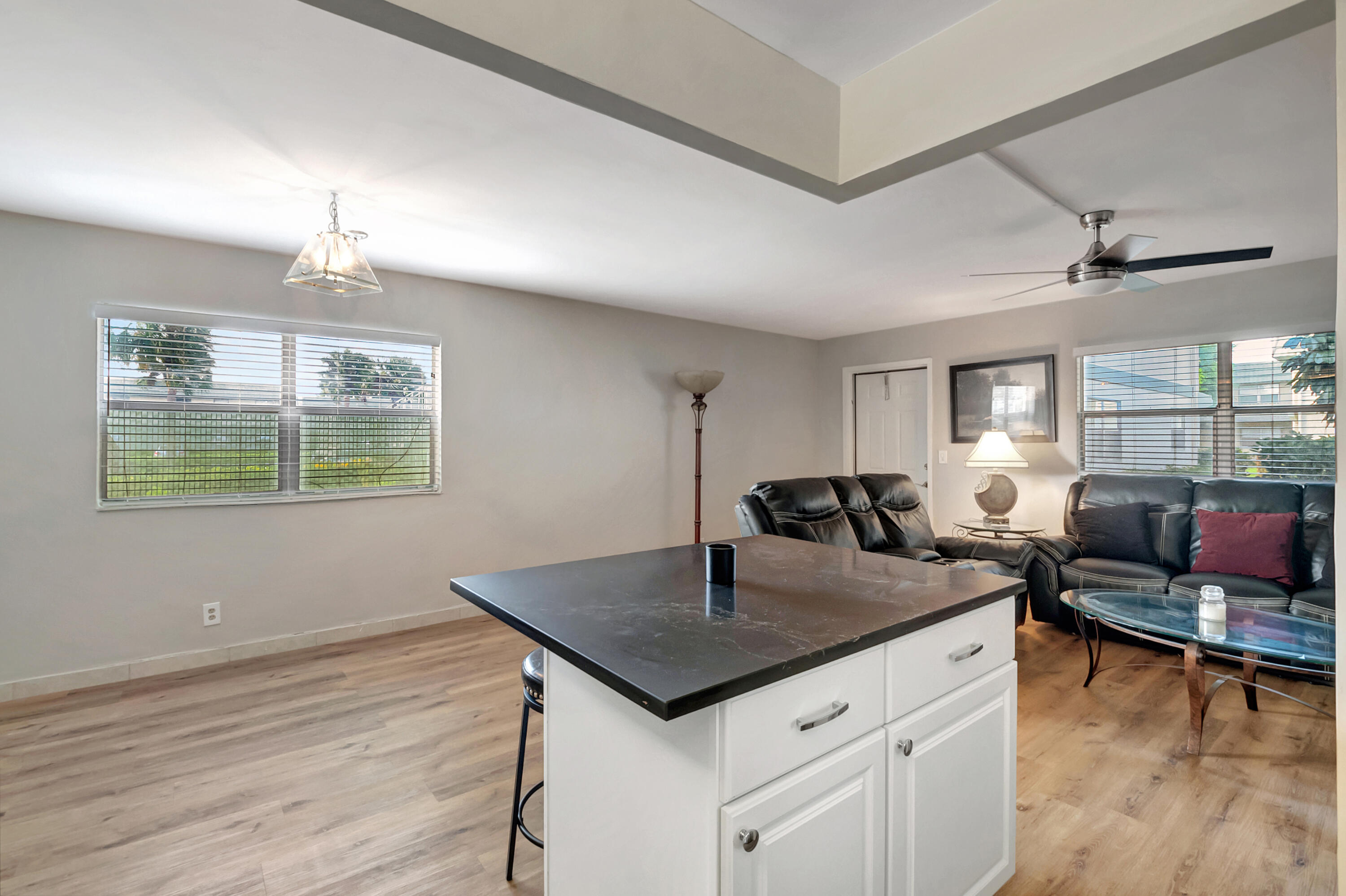 195 Monaco Way, Unit 195 Delray Beach, FL 33446 - Photo 12 of 64 a living room with furniture and a wooden floor