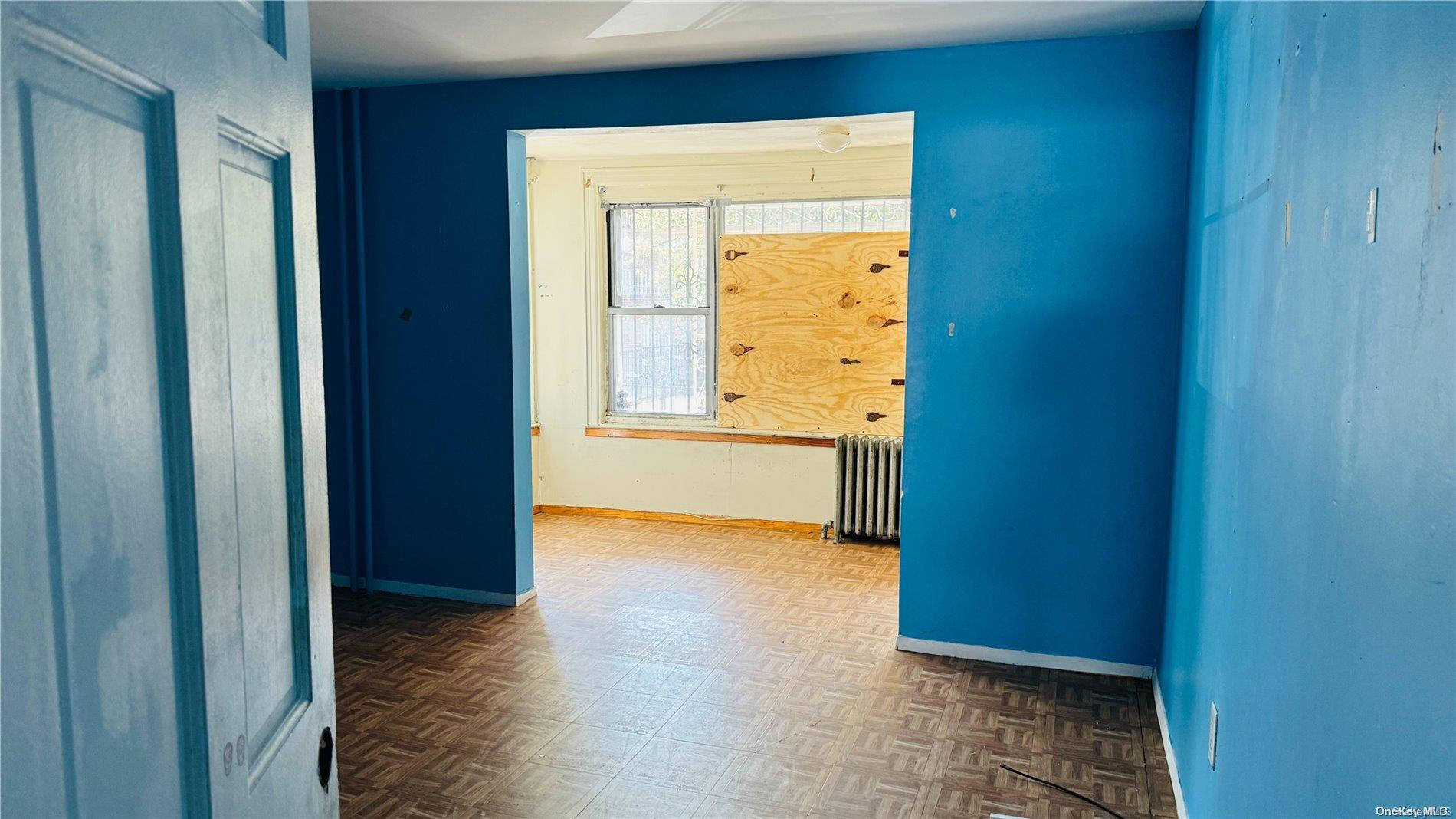 37-33 97th Street Queens, NY 11368 - Photo 3 of 14 a view of an empty room with a window