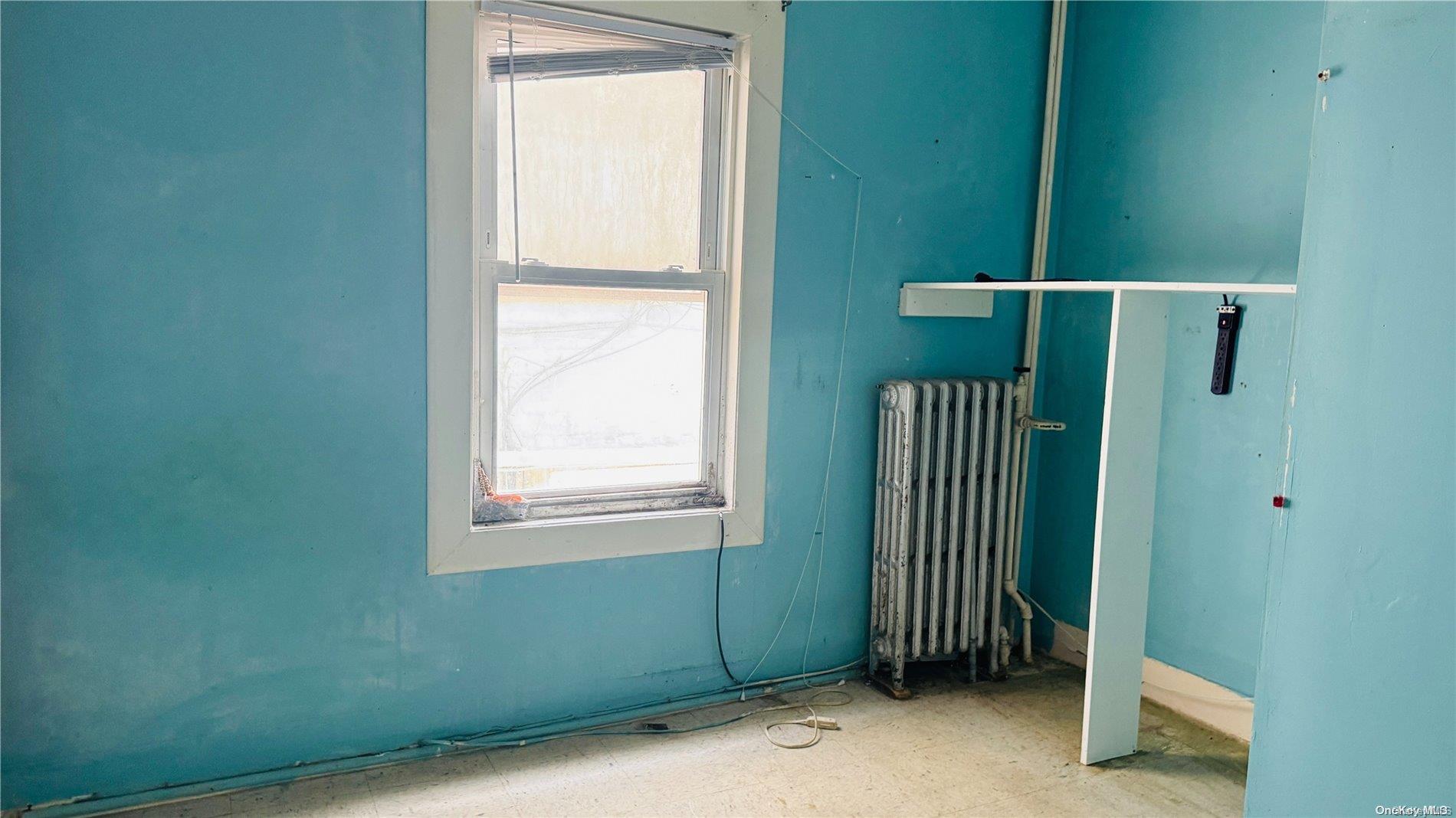 37-33 97th Street Queens, NY 11368 - Photo 6 of 14 a view of an empty room with a window