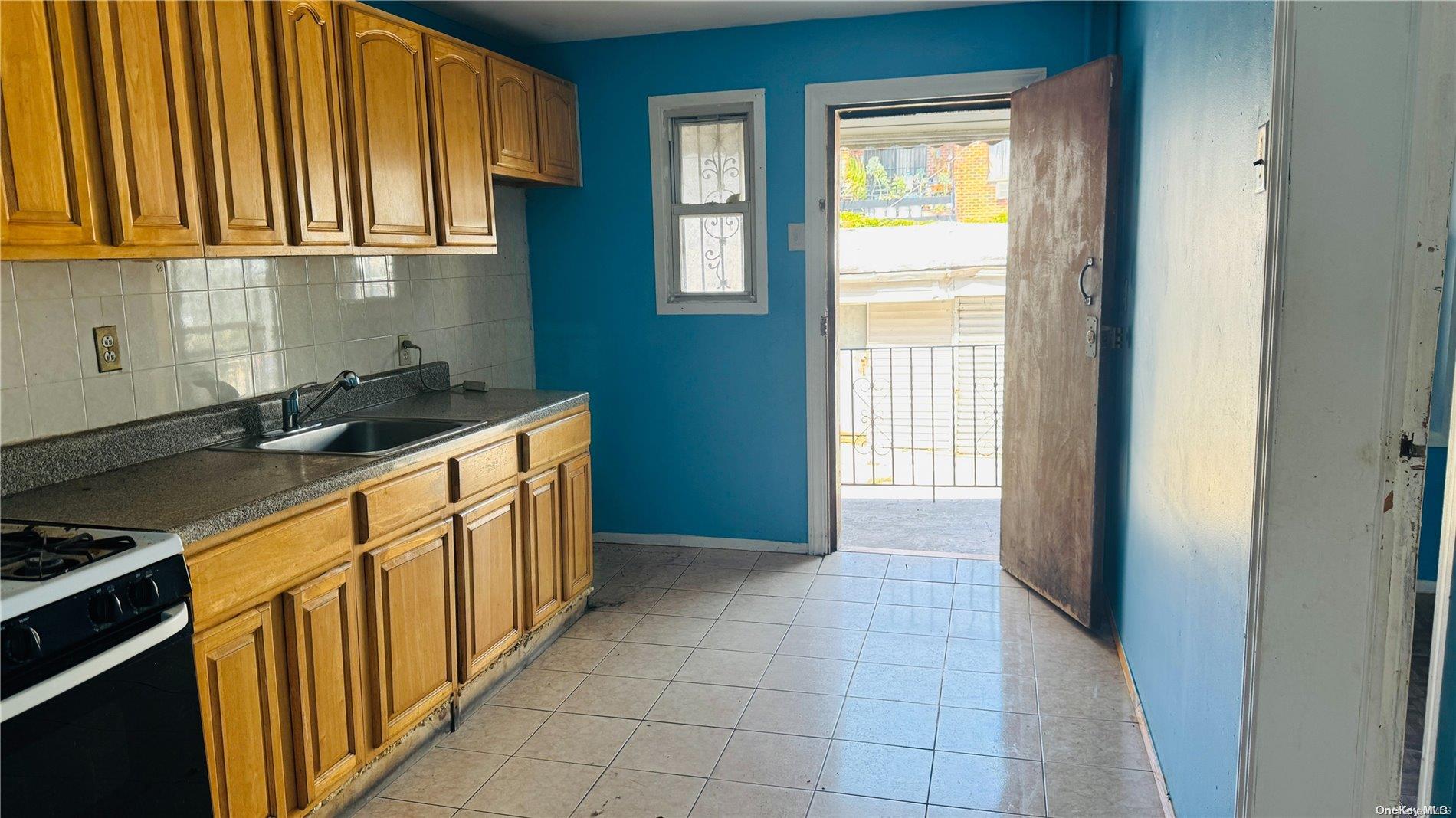37-33 97th Street Queens, NY 11368 - Photo 7 of 14 a kitchen with a sink and a refrigerator