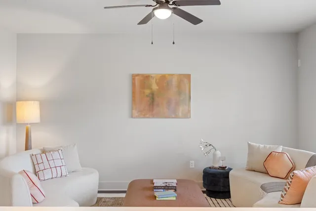 a living room with furniture and a lamp