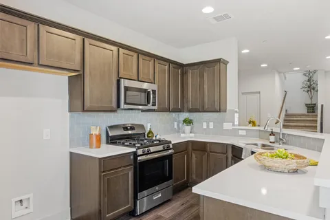 a kitchen that has a sink and a stove in it